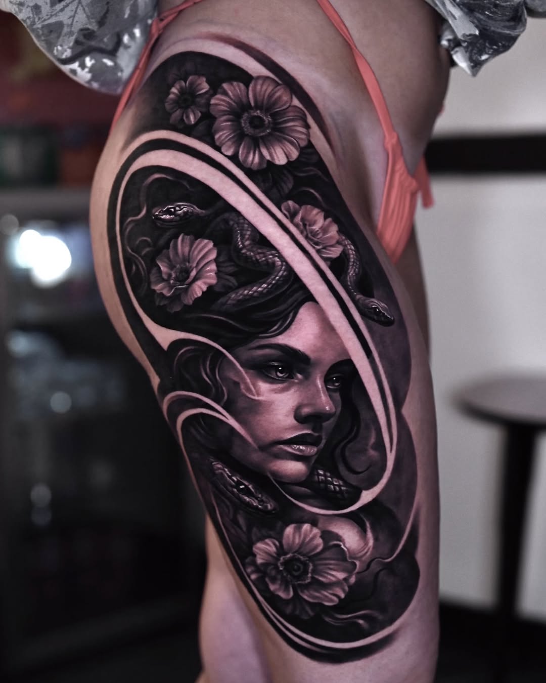 Medusa with snakes and flowers realism tattoo on the thigh by Marcos Salamanca
