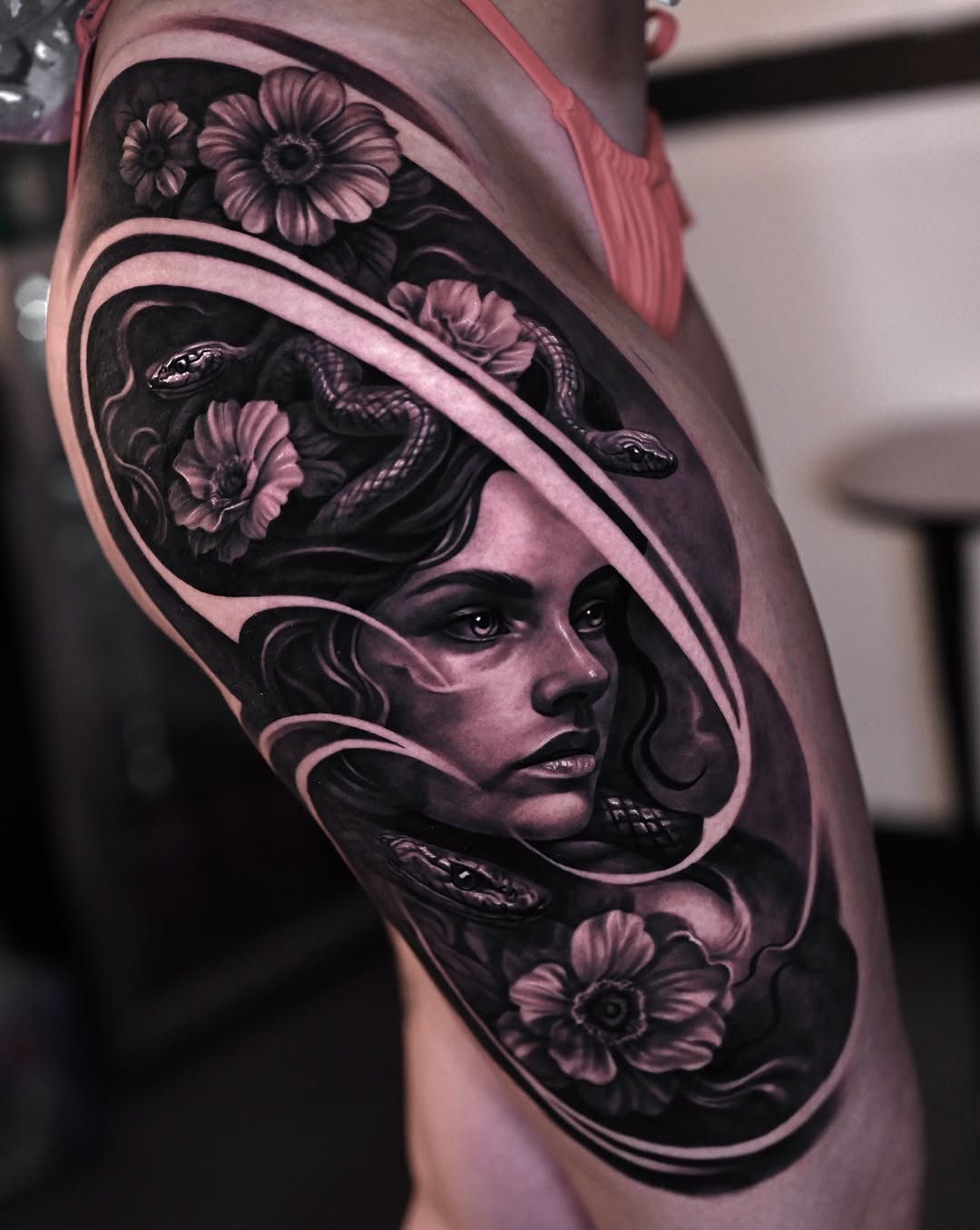 Medusa with snakes and flowers realism tattoo on the shoulder by Marcos Salamanca