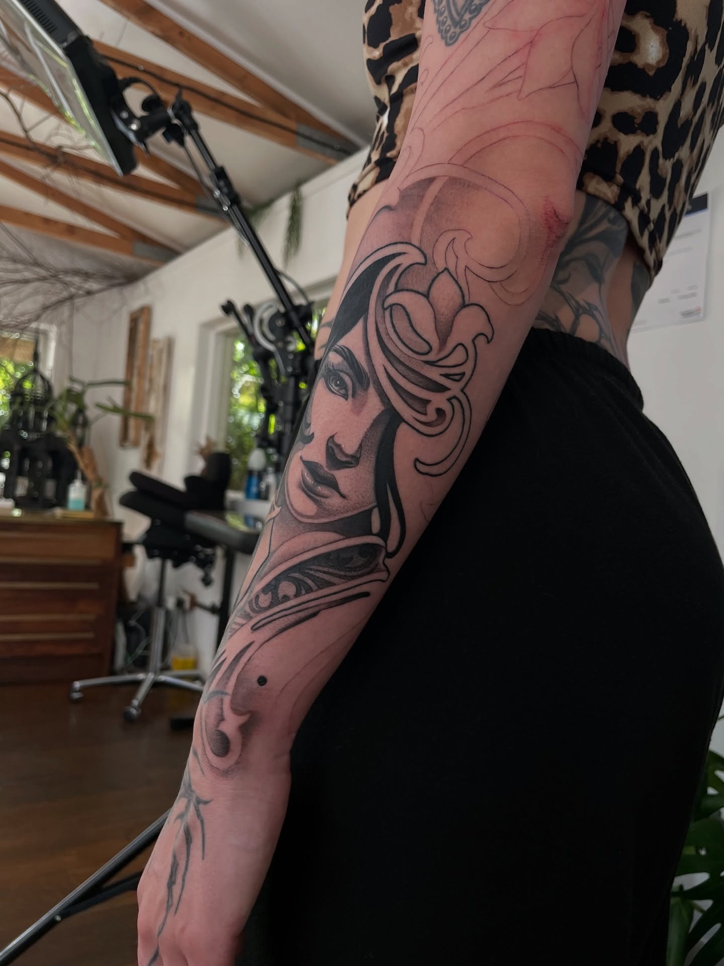 Woman's face dotwork tattoo on the forearm by Michelle Carlton