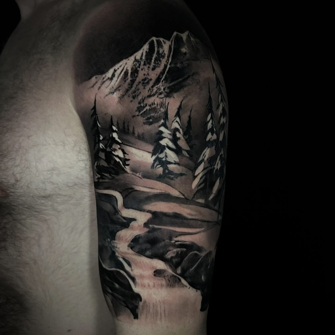 Mountain landscape realism tattoo on the forearm by Nathan Adsit