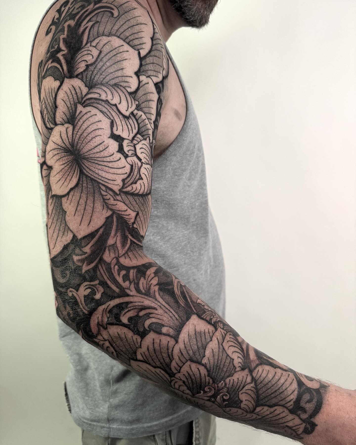 Floral design black and grey tattoo on the upper arm by Jamie Beach, Wheat Ridge, Colorado