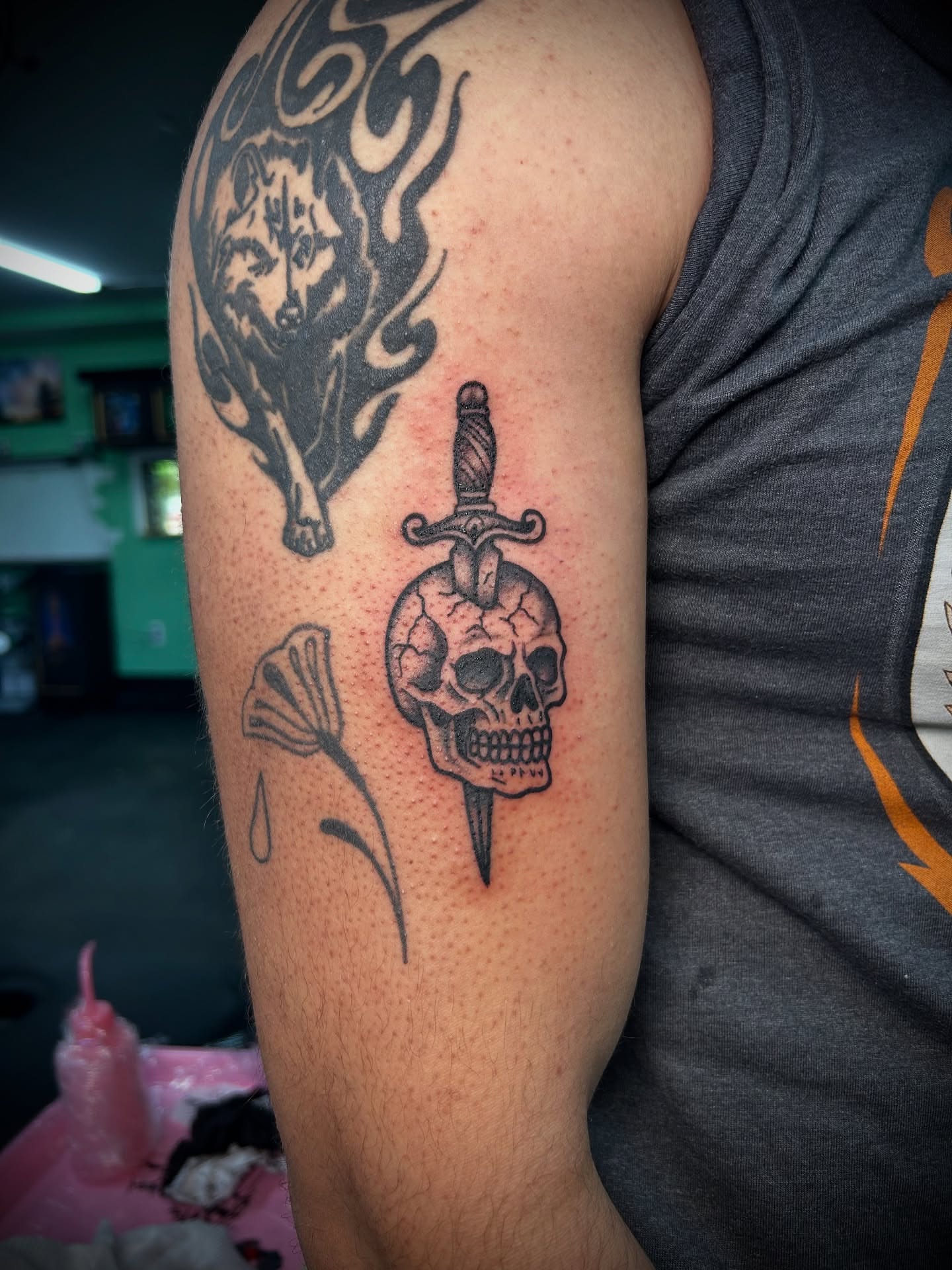 Skull with dagger black and grey tattoo on the forearm by Kiersten Tickle