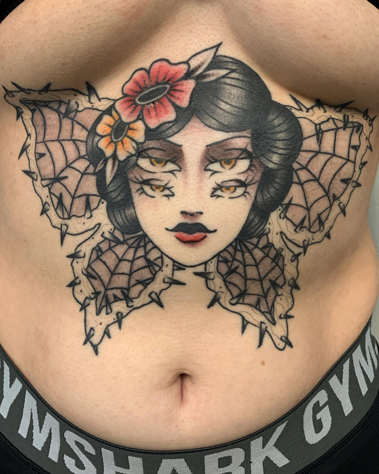 Woman with flowers American traditional tattoo on the chest by Brii Moser