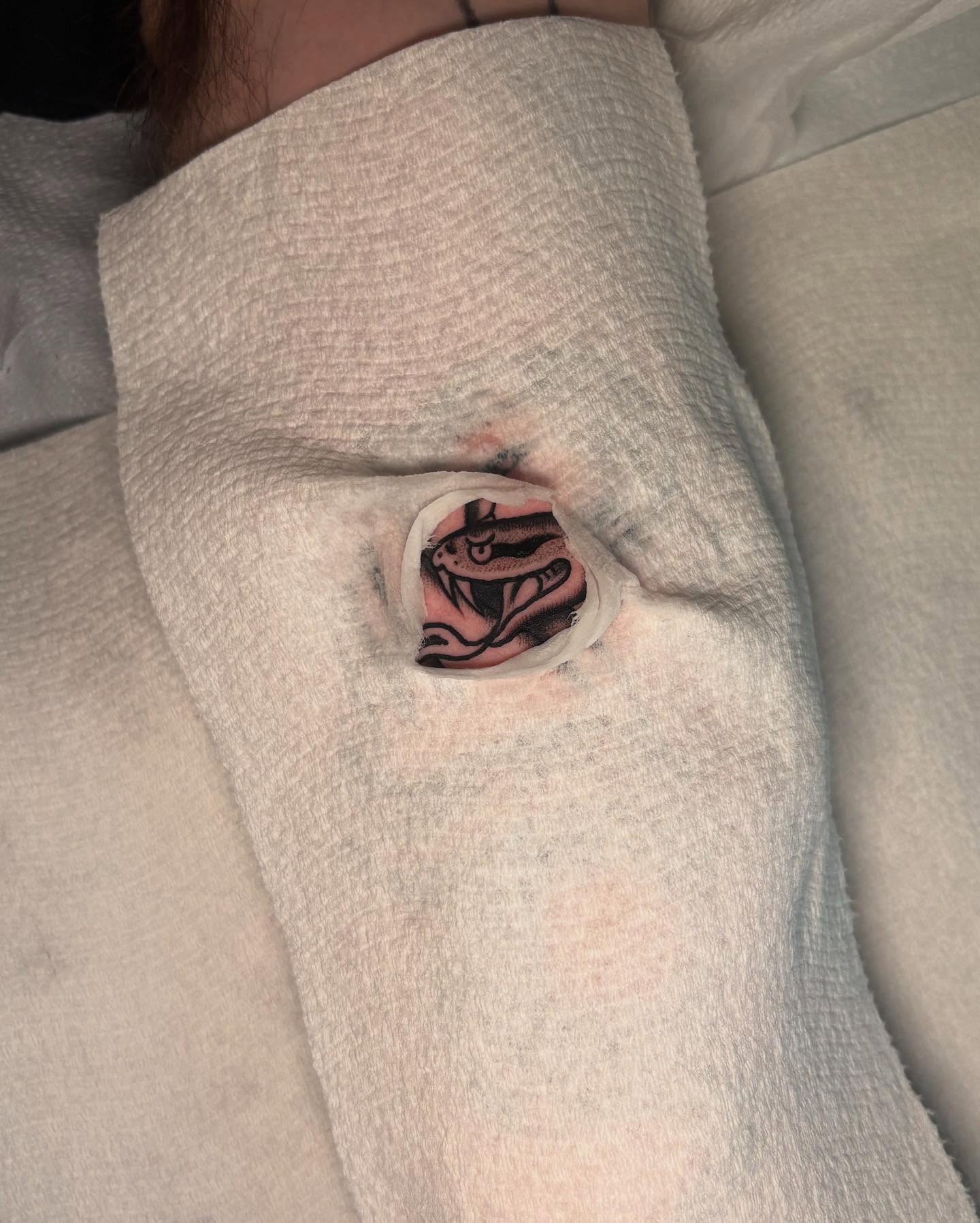 Snake American traditional tattoo on the thigh by Lily, Eugene, Oregon