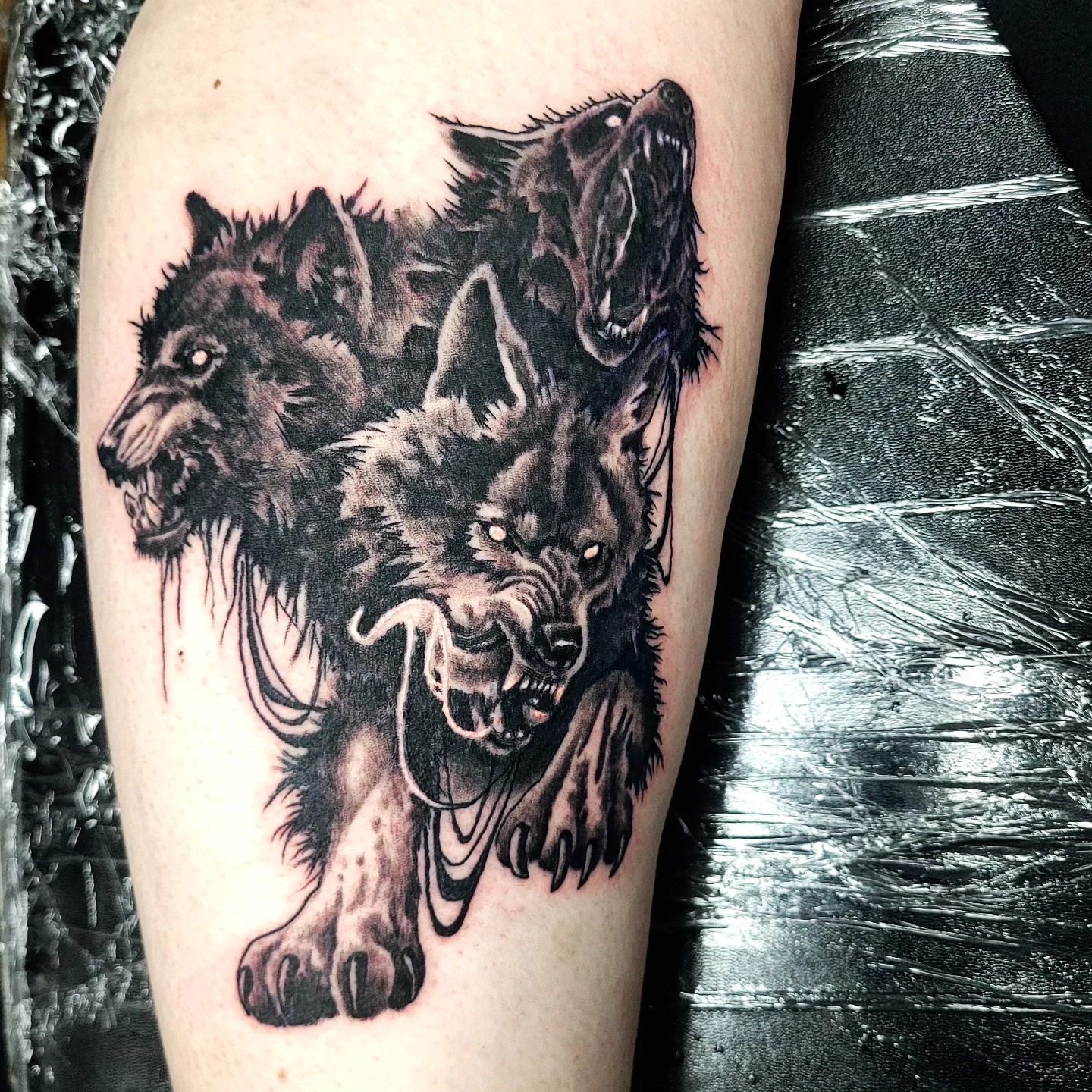 Wolves dark realism tattoo on the thigh by Jentrey McCausland