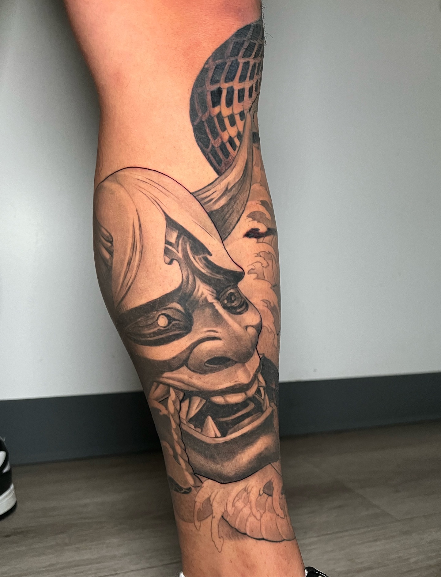 Demon mask realism tattoo on the forearm by Johnson