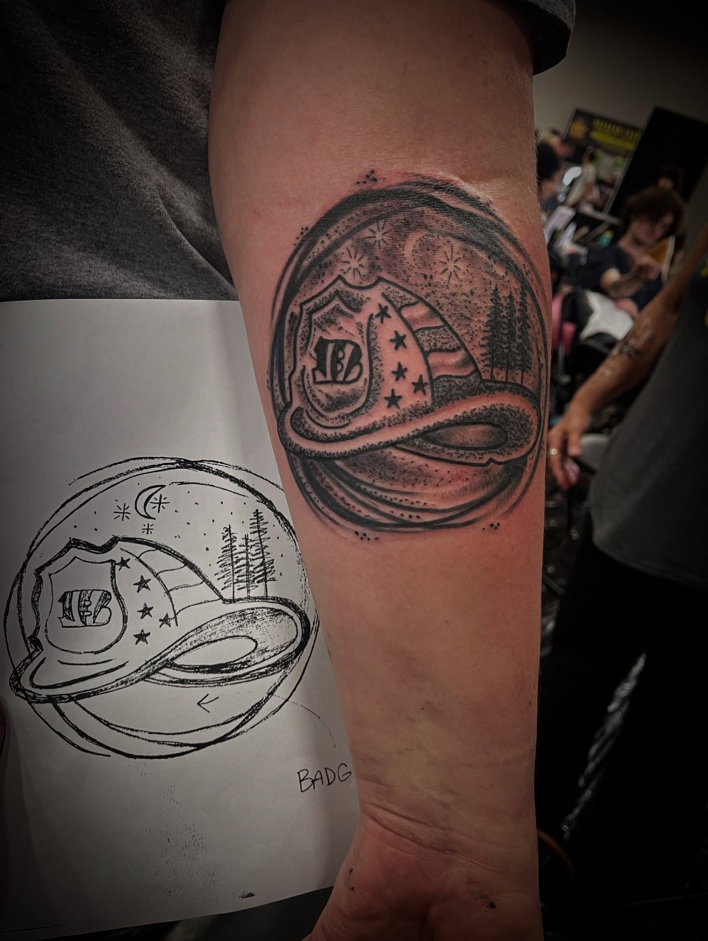 Space badge black and grey tattoo on the forearm by Don Juan
