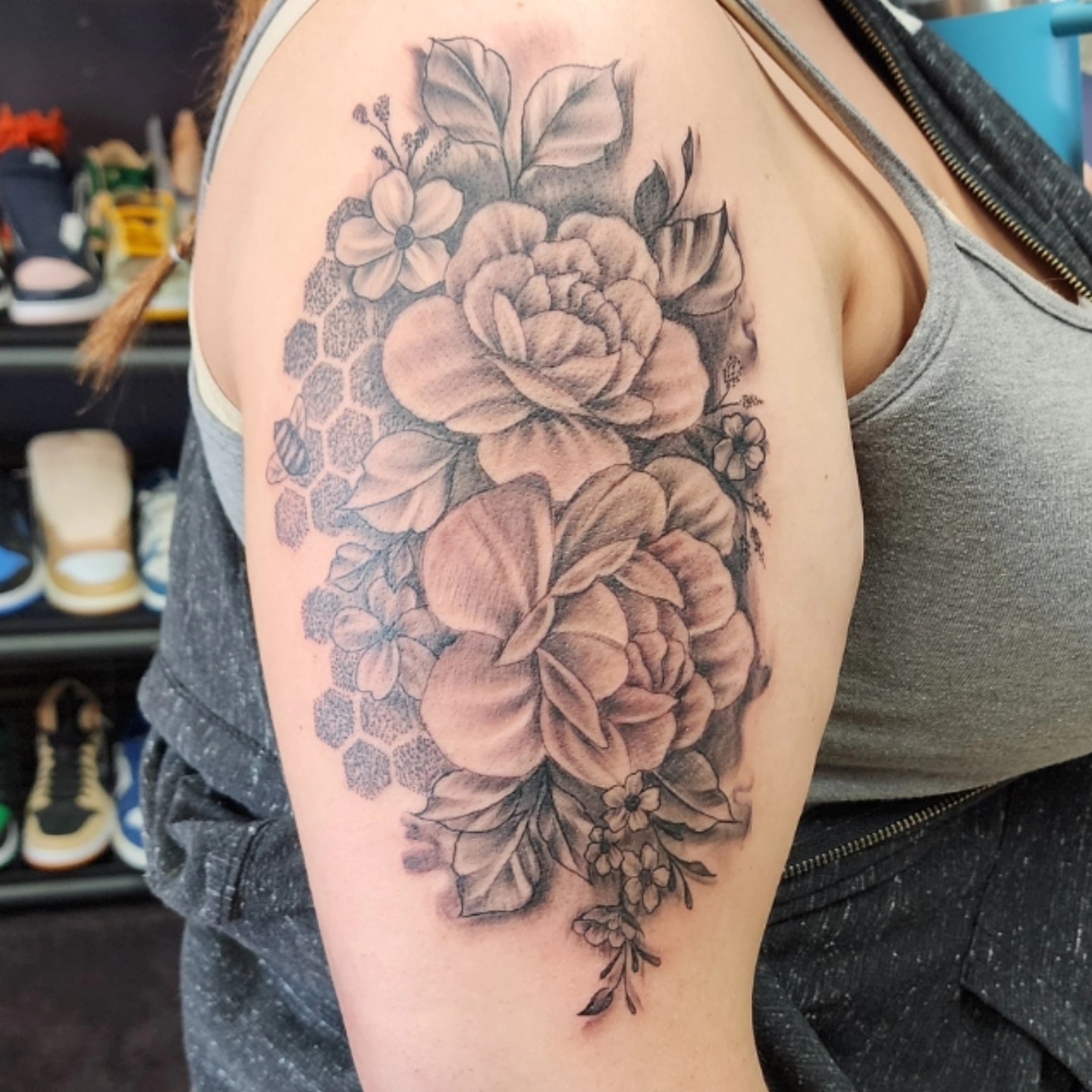 Floral bouquet realism tattoo on the shoulder by Dennis Foust