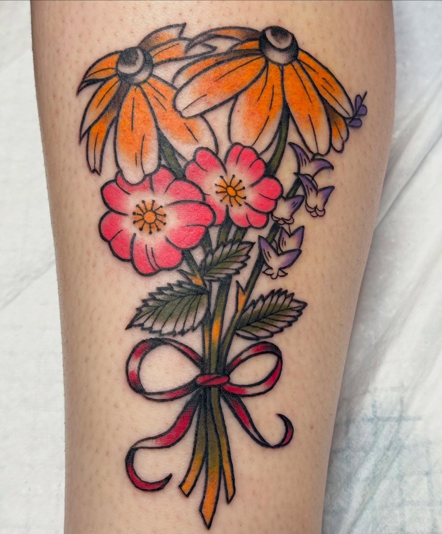 Flower bouquet American traditional tattoo on the forearm by Kelsey Turnis