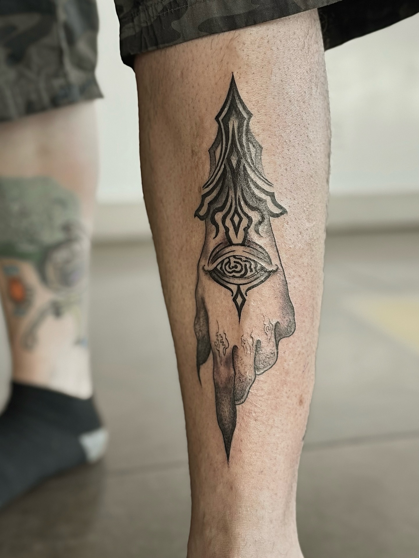 Eye and spear geometric tattoo on the calf by Jewels, St. George, Utah