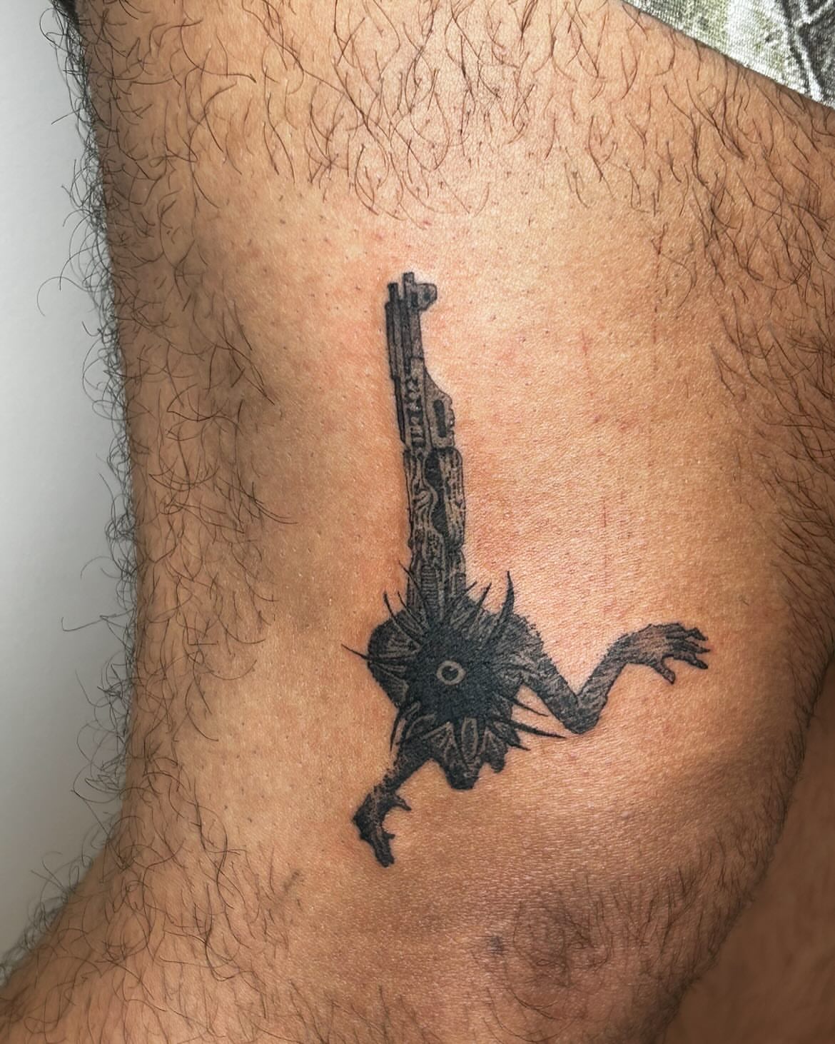Keyblade black and grey tattoo on the thigh by Jadin Nichols