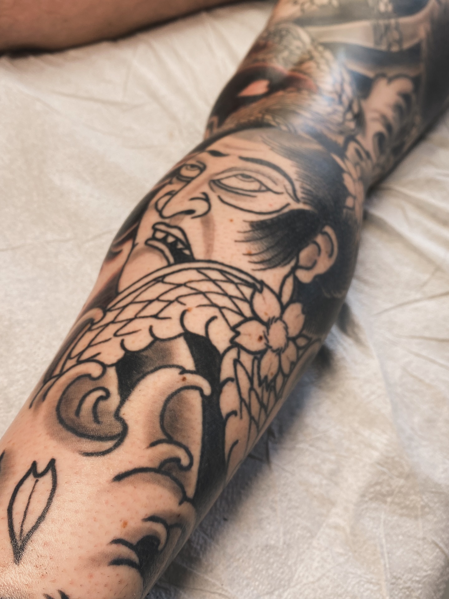 Man with bird American traditional tattoo on the forearm by Stephen Shaw