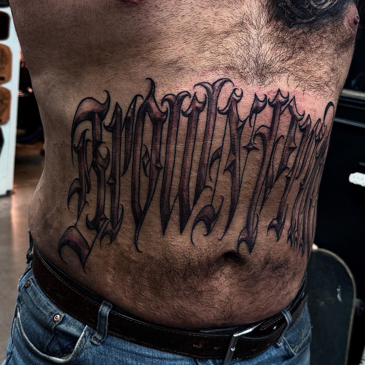 Script lettering lettering script tattoo on the torso by Joey Moreno