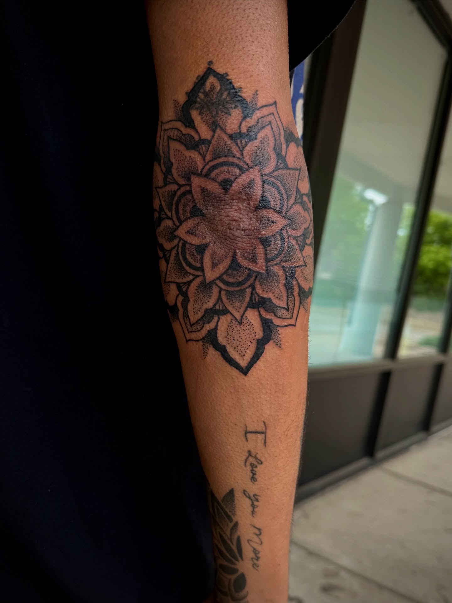 Lotus flower dotwork tattoo on the forearm by Stevie Reign