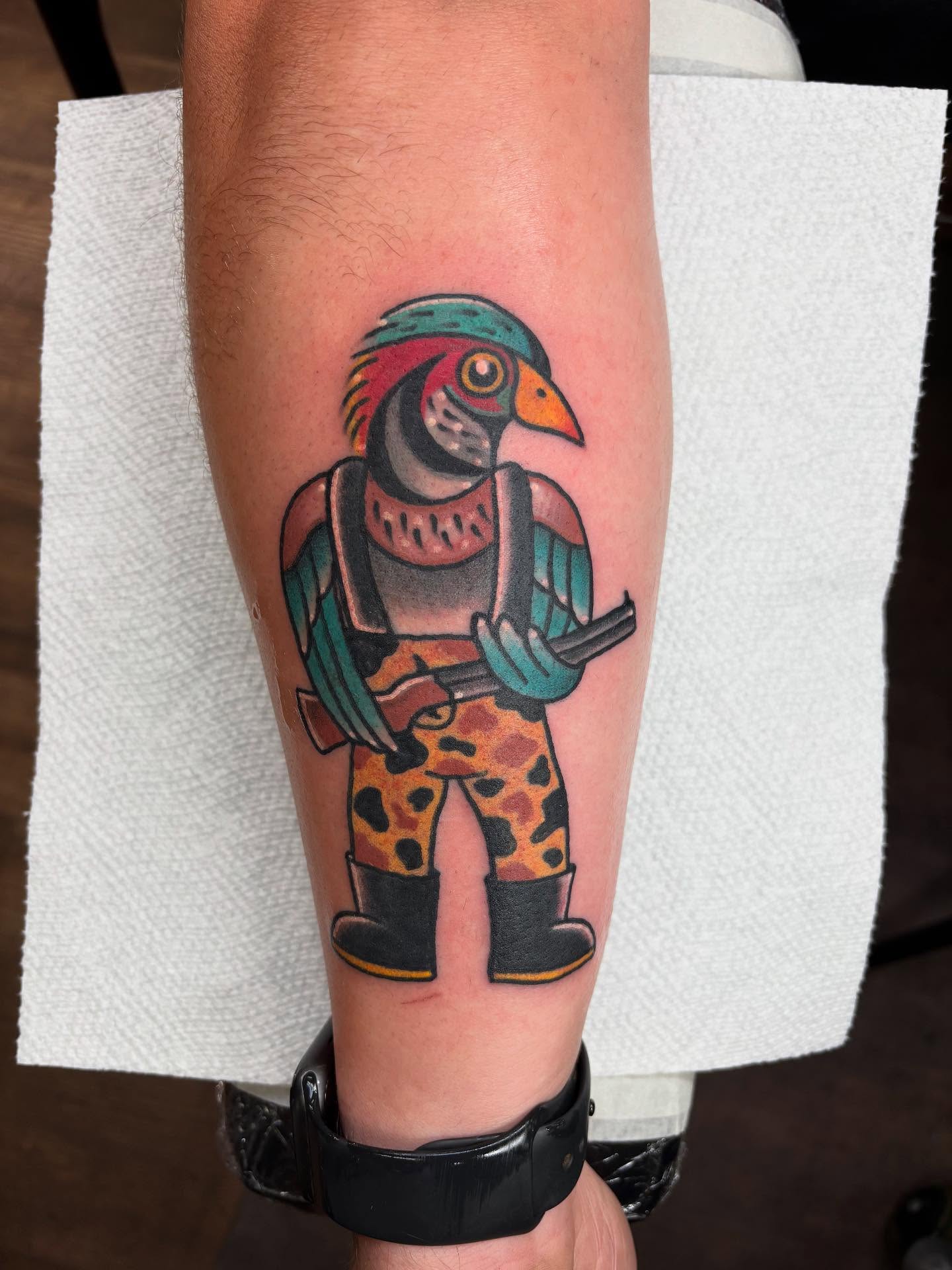 Bird in camouflage pants American traditional tattoo on the forearm by Dave