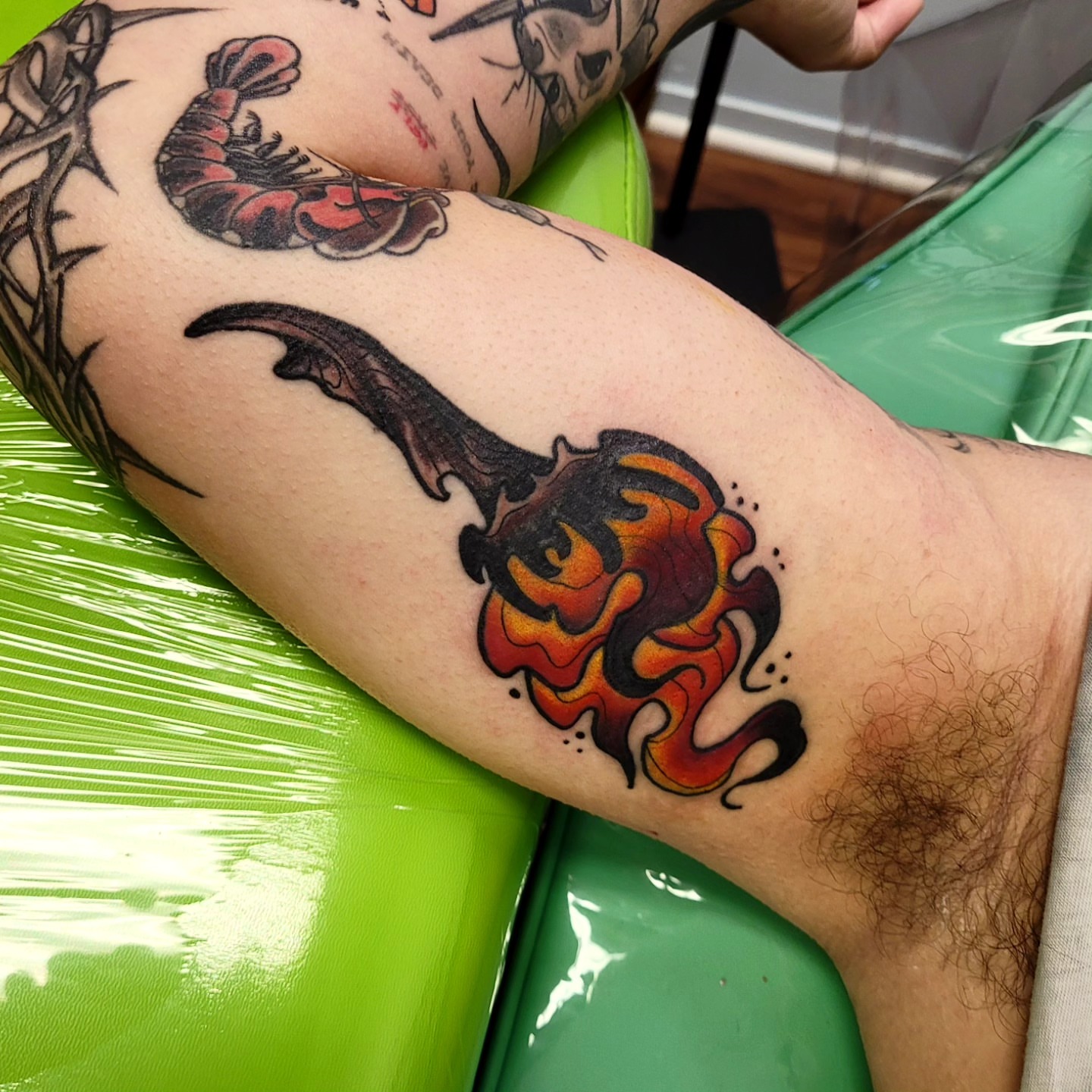 Flame American traditional tattoo on the forearm by Wray Saulsberry