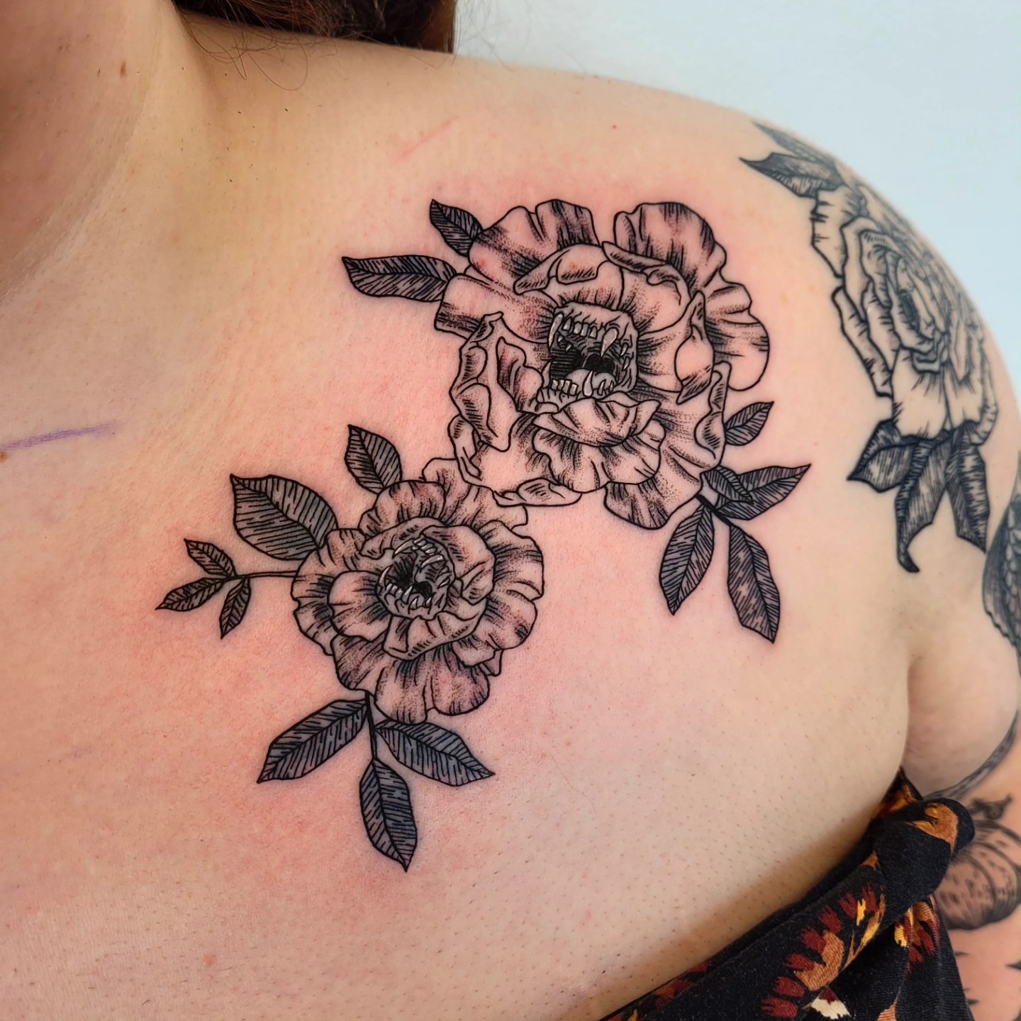 Roses black and grey tattoo on the shoulder by Wray Saulsberry