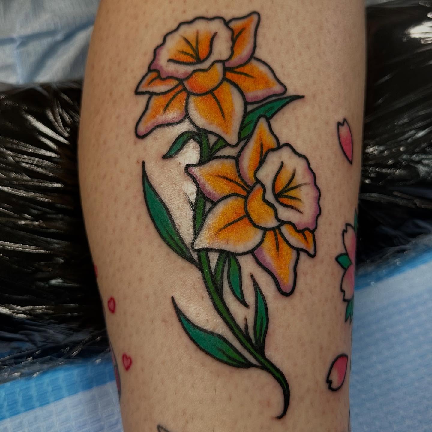 Daffodils American traditional tattoo on the forearm by Olive Kelley