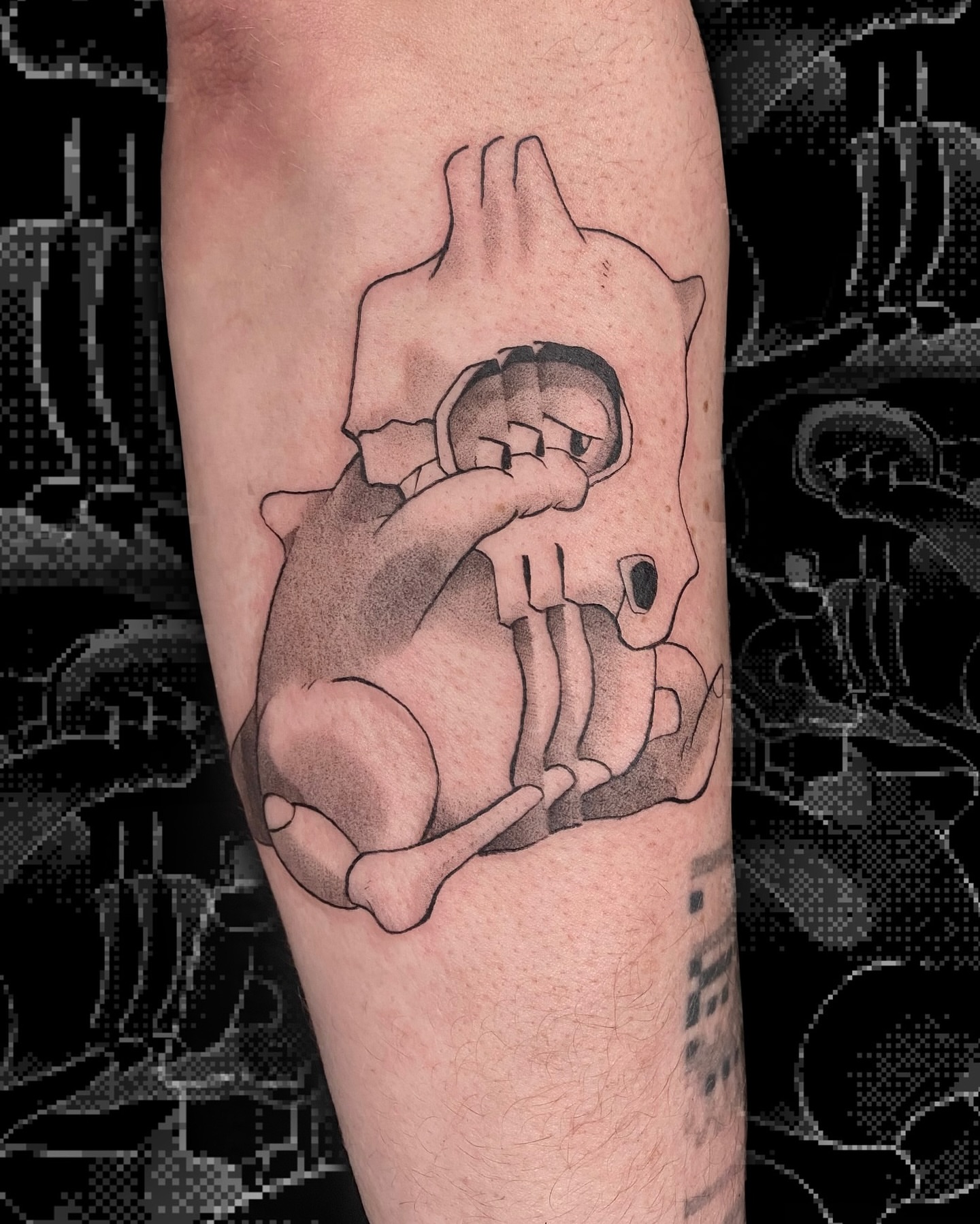 Child in hand black and grey tattoo on the forearm by Sarah