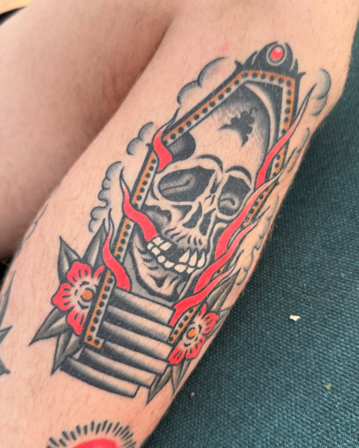 Skull and ribbon American traditional tattoo on the forearm by Chaz Otto