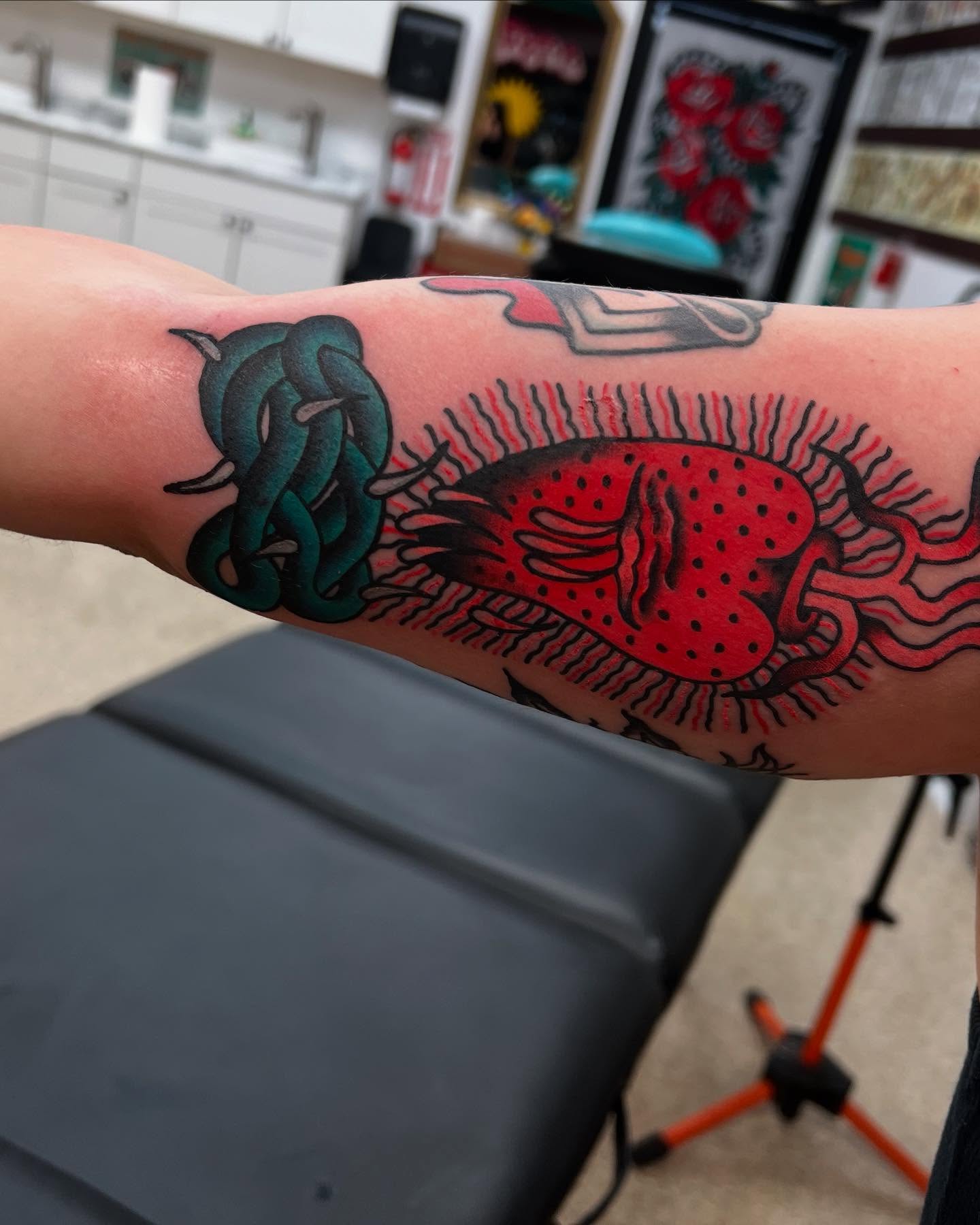 Octopus and lobster American traditional tattoo on the forearm by Atom Aker