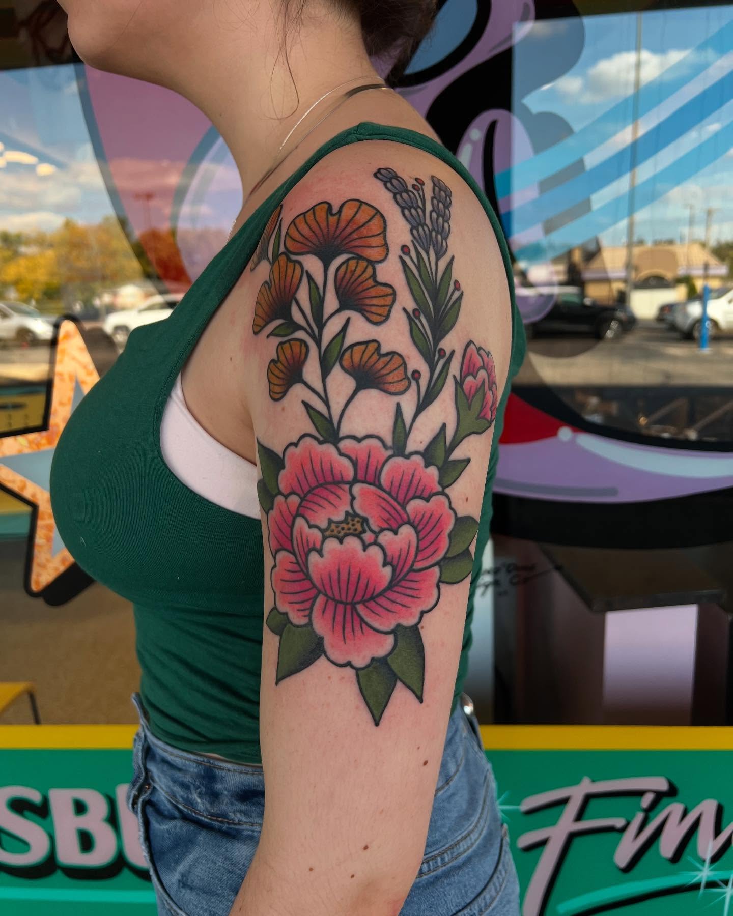 Peony and poppies American traditional tattoo on the upper arm by Atom Aker