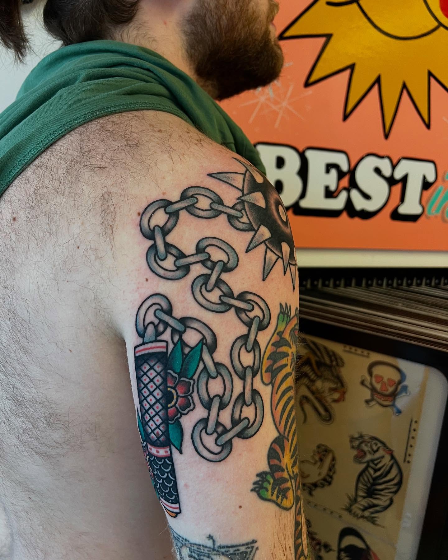 Chains and dagger American traditional tattoo on the upper arm by Atom Aker