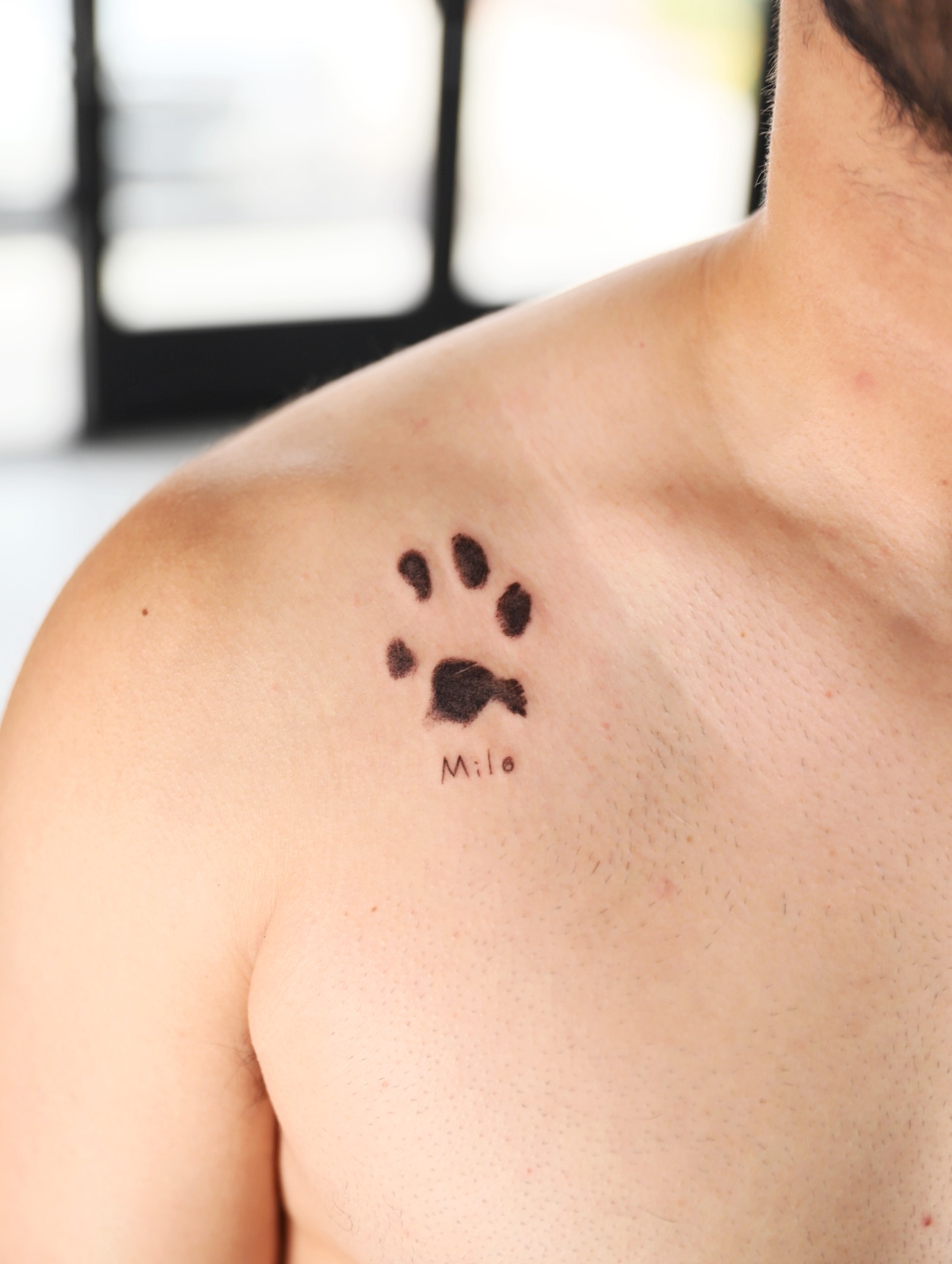 Paw print dotwork tattoo on the chest by Las Vegas tattoo