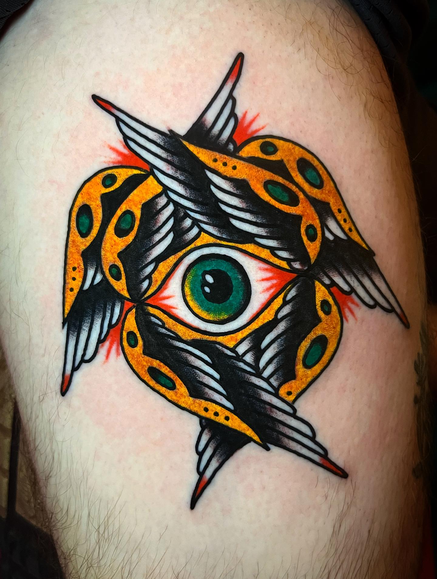 Eye with wings American traditional tattoo on the thigh by Jake LiCausi