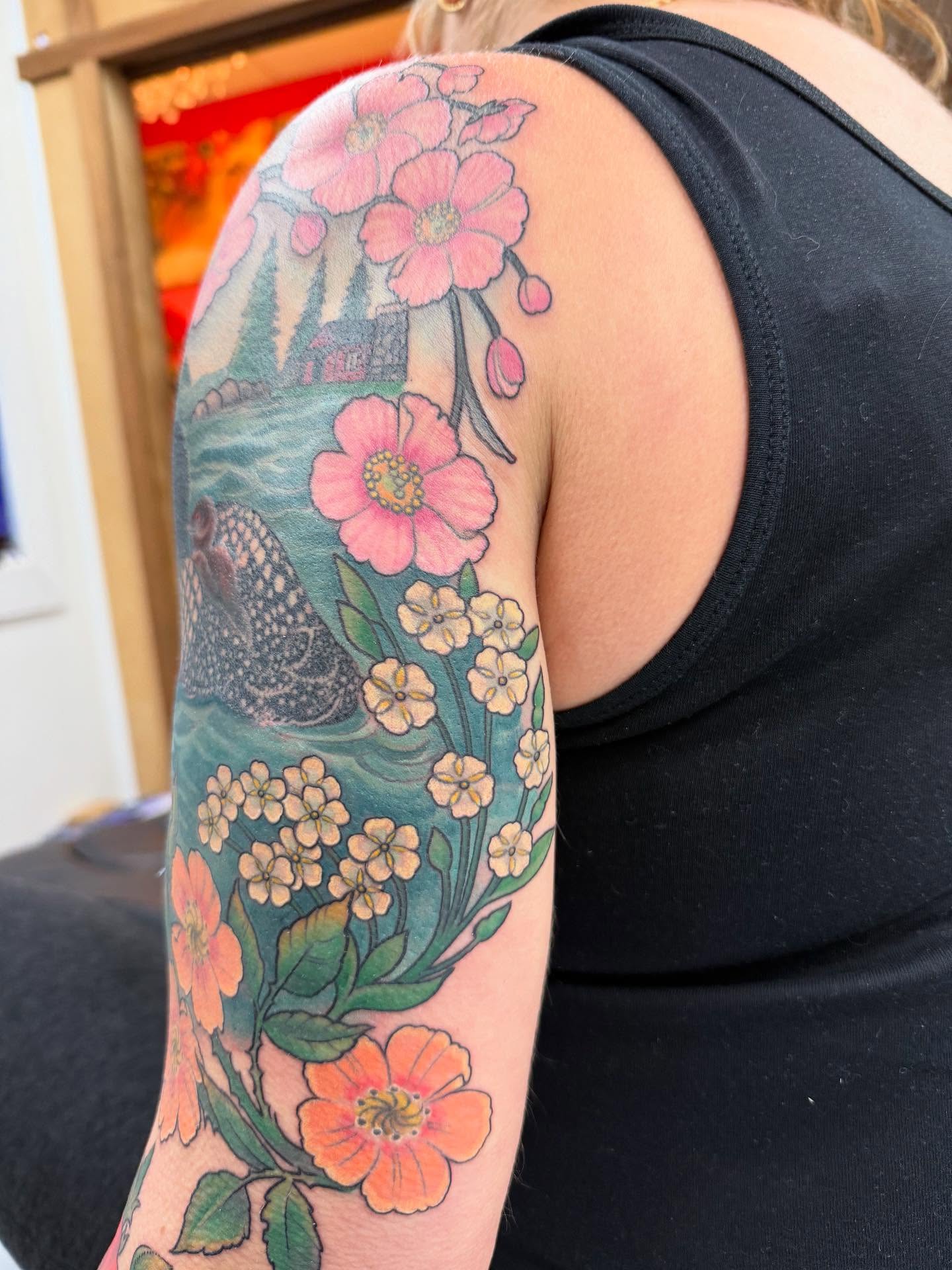 Floral landscape new school tattoo on the upper arm by Hori Bensei, Charlottesville, Virginia