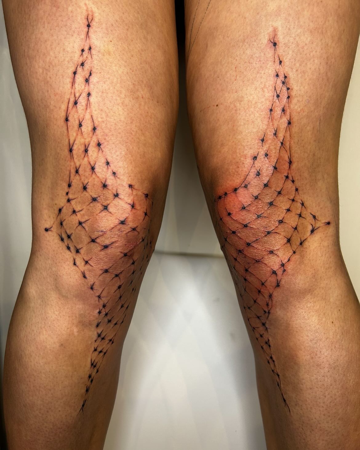 Geometric net dotwork tattoo on the leg by Jadin Nichols