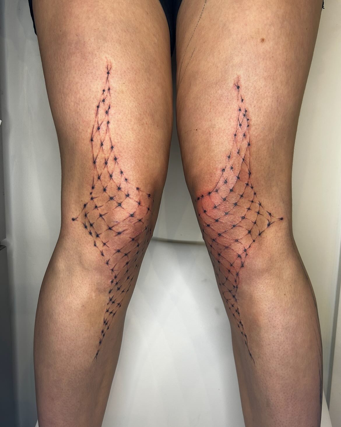 Geometric net dotwork tattoo on the leg by Jadin Nichols