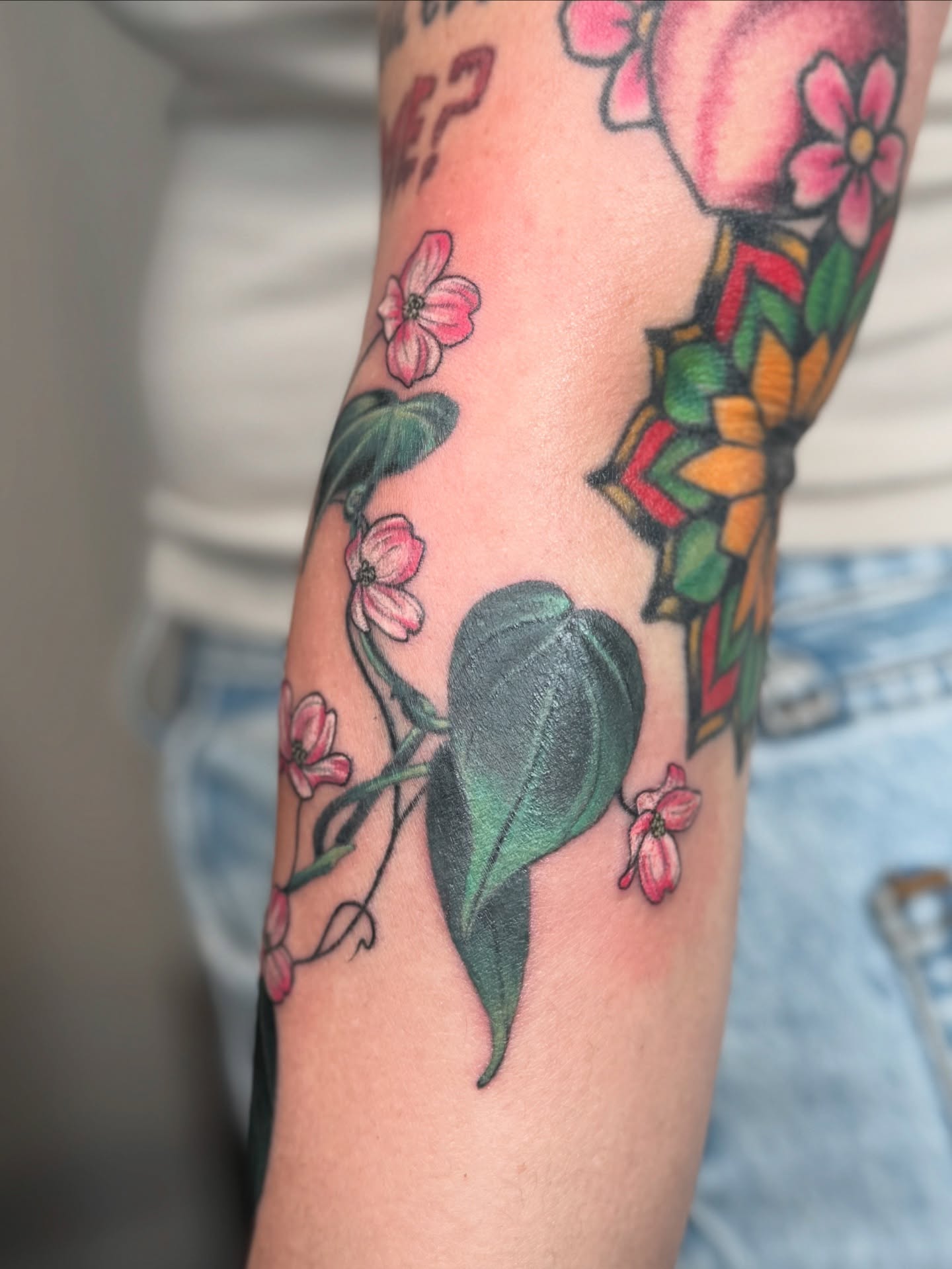 Flowers and butterfly American traditional tattoo on the forearm by Sydney