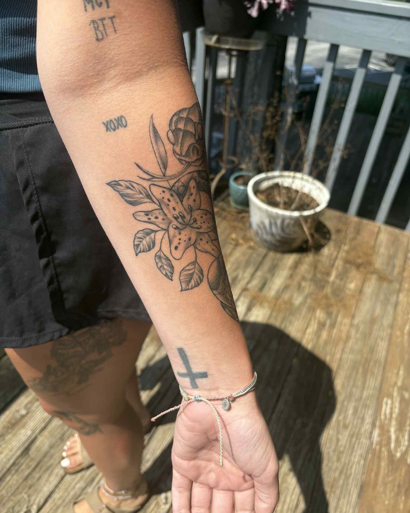 Floral arrangement black and grey tattoo on the forearm by Brandon Anderson