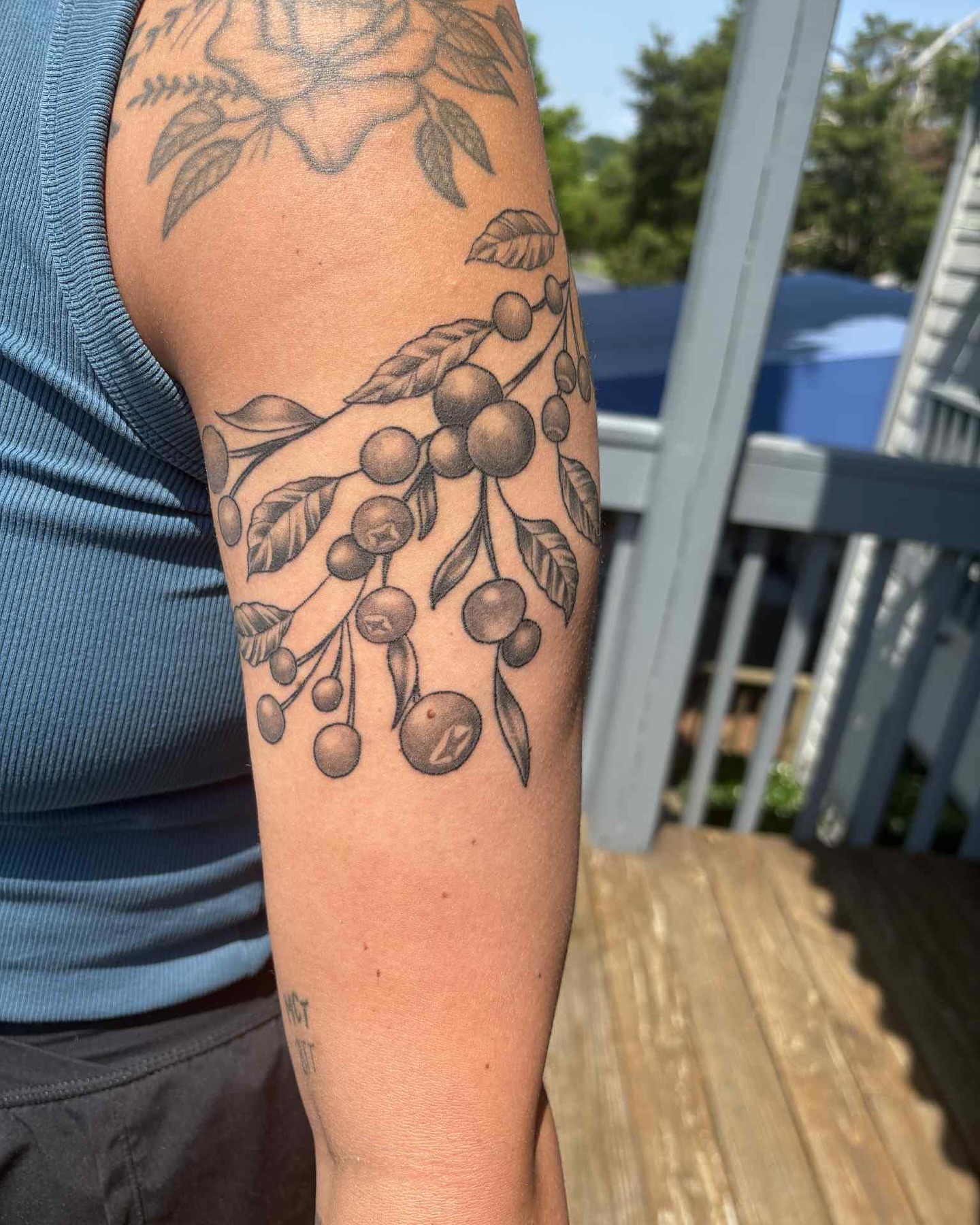 Cherry branch black and grey tattoo on the forearm by Brandon Anderson