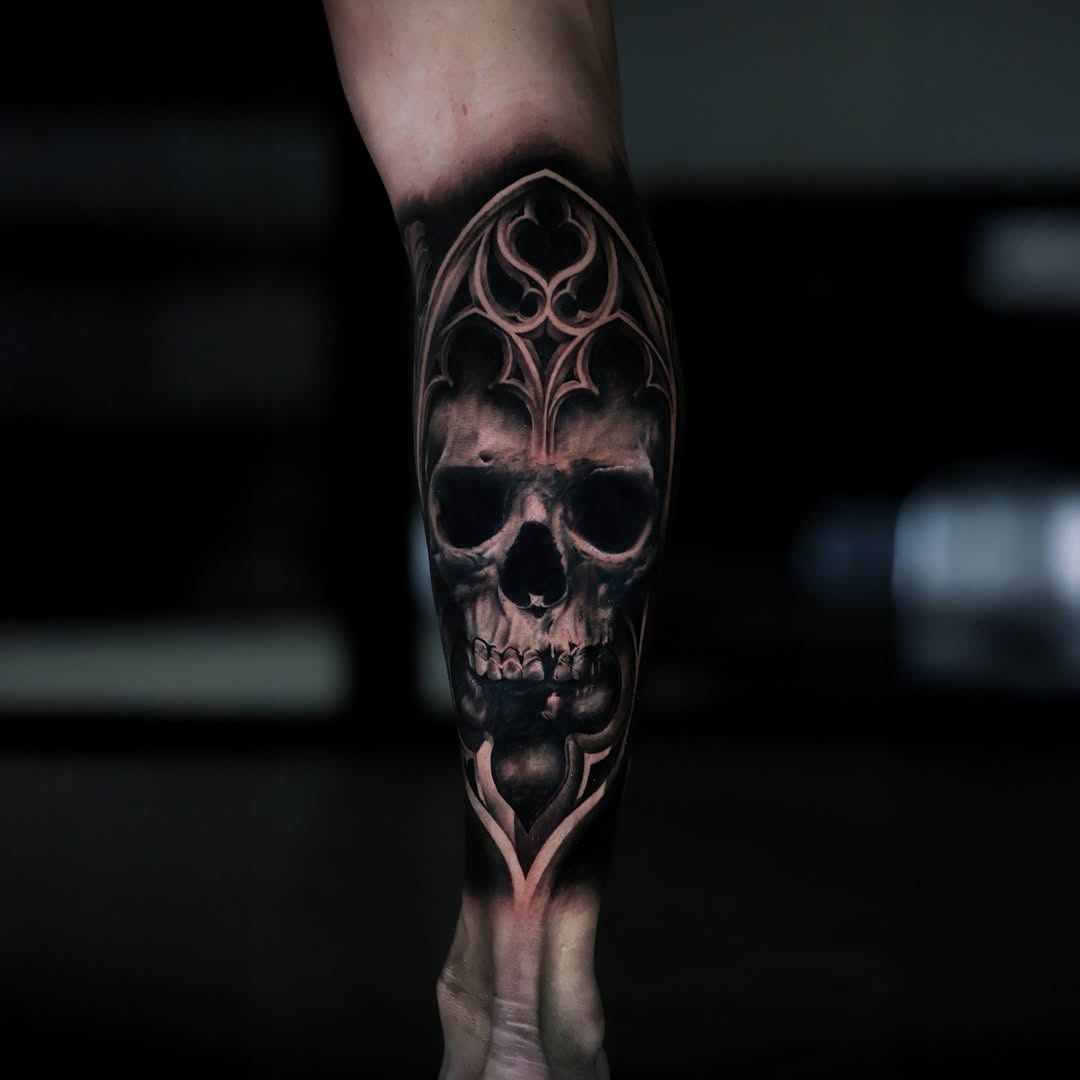 Skull with gothic arch dark art tattoo on the forearm by Felipe Andrade