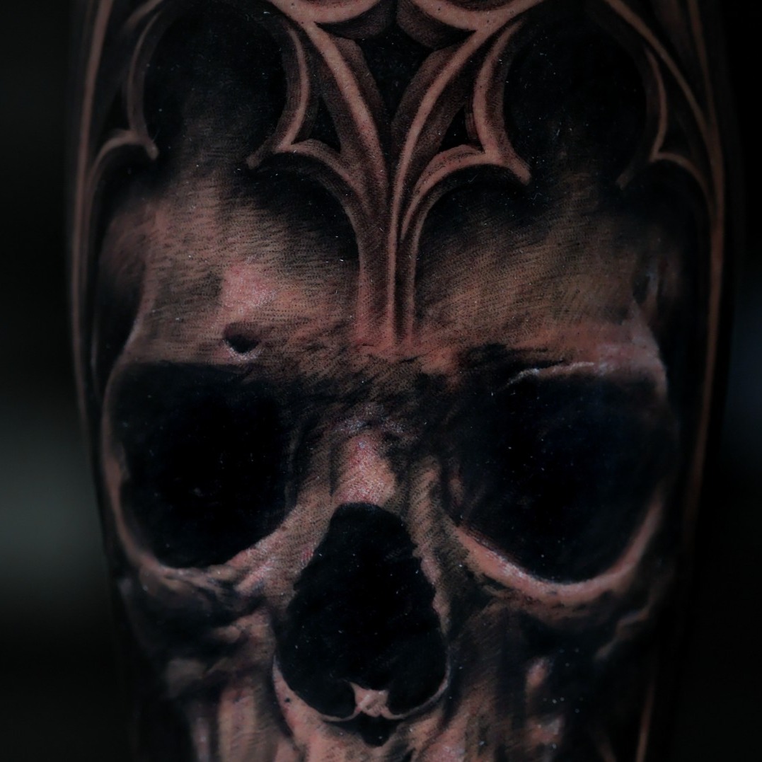 Skull with gothic archway dark art tattoo on the forearm by Felipe Andrade