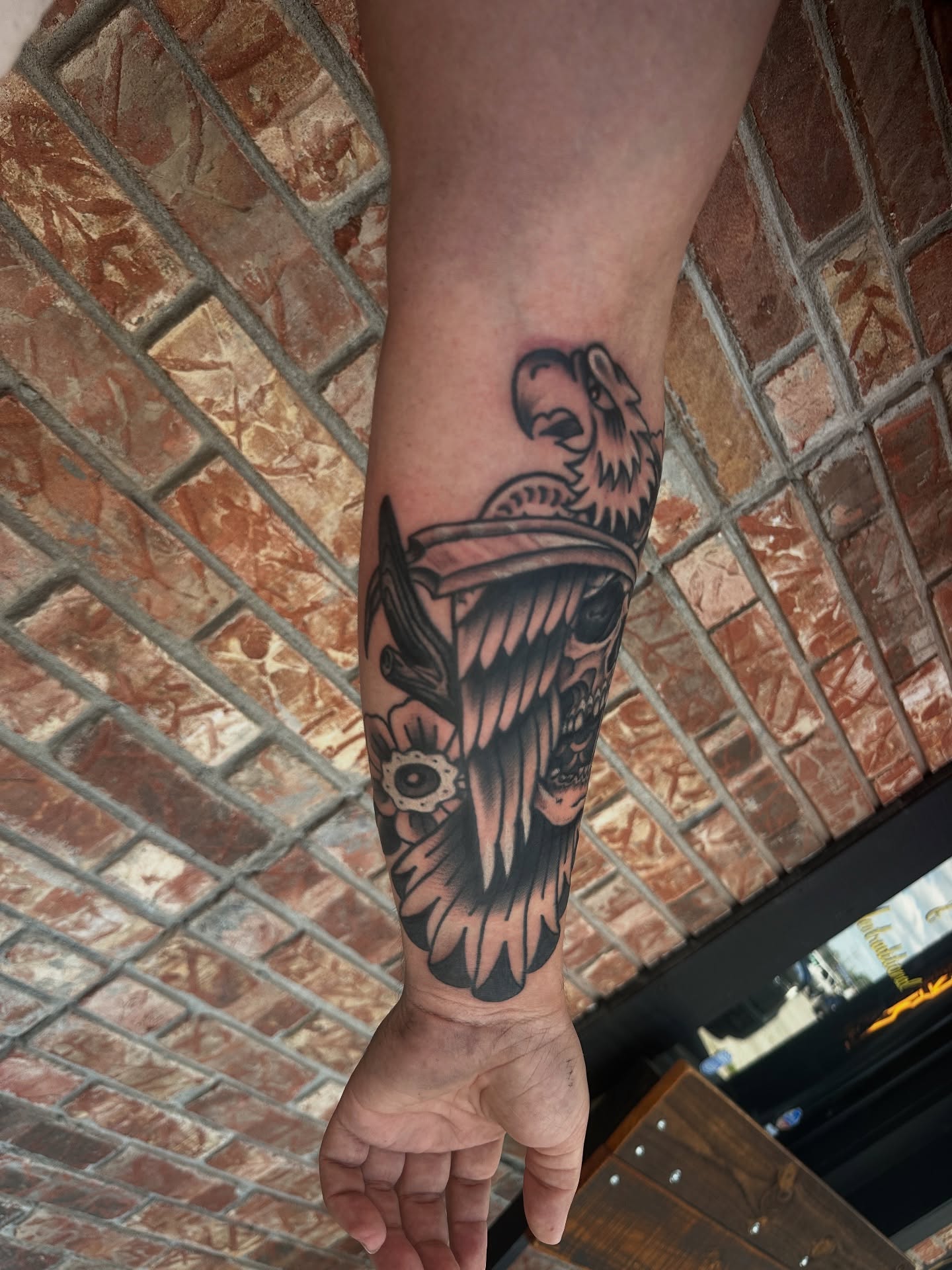 Skull with eagle and flower tattoo on the forearm by Matthew Tattooer Harman