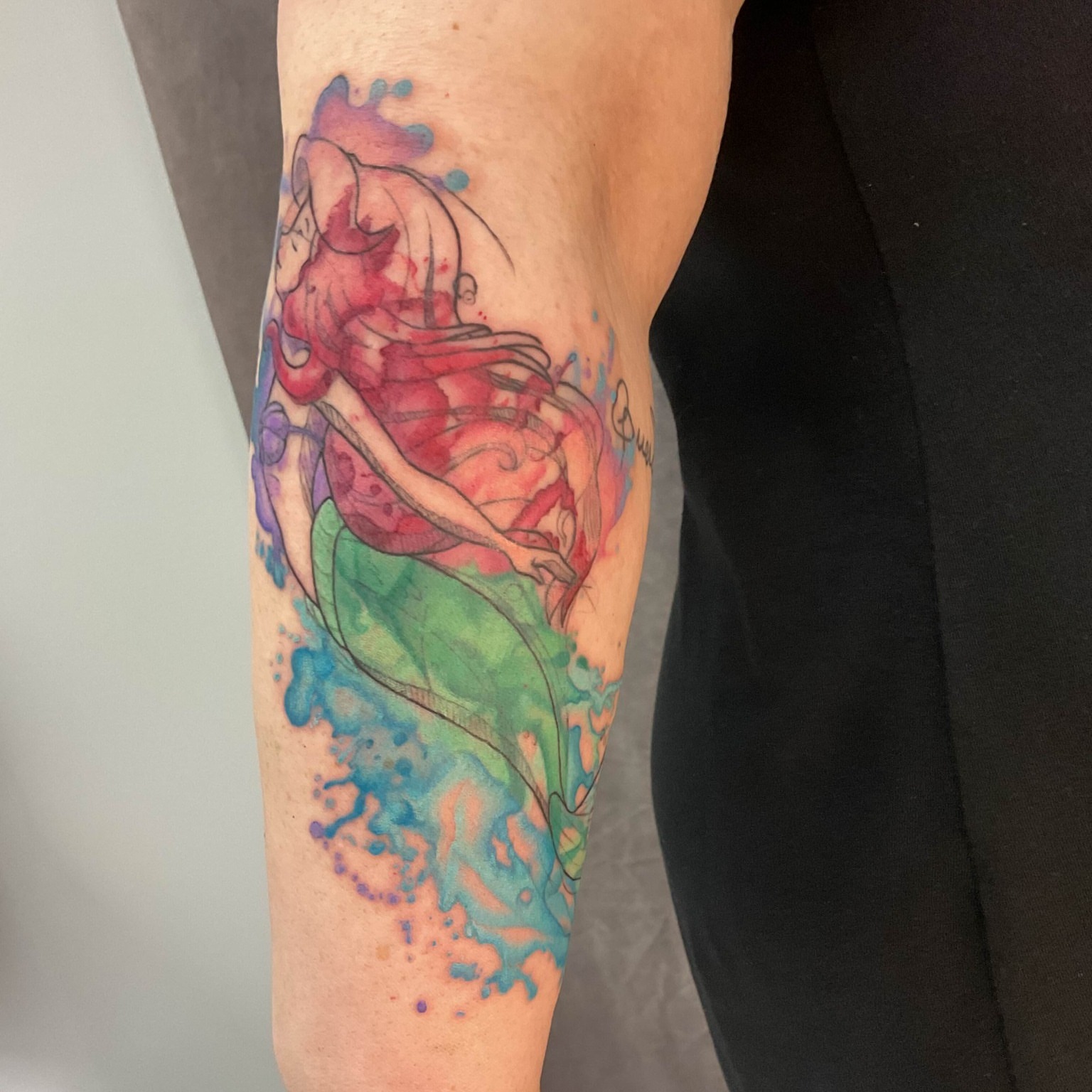 Mermaid watercolor tattoo on the forearm by Iram Withencroft