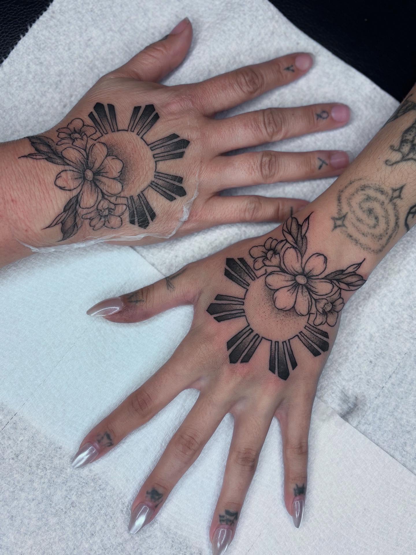 Sun and flowers black and grey tattoo on the hand by π»πΈπ½π½, Ypsilanti, Michigan