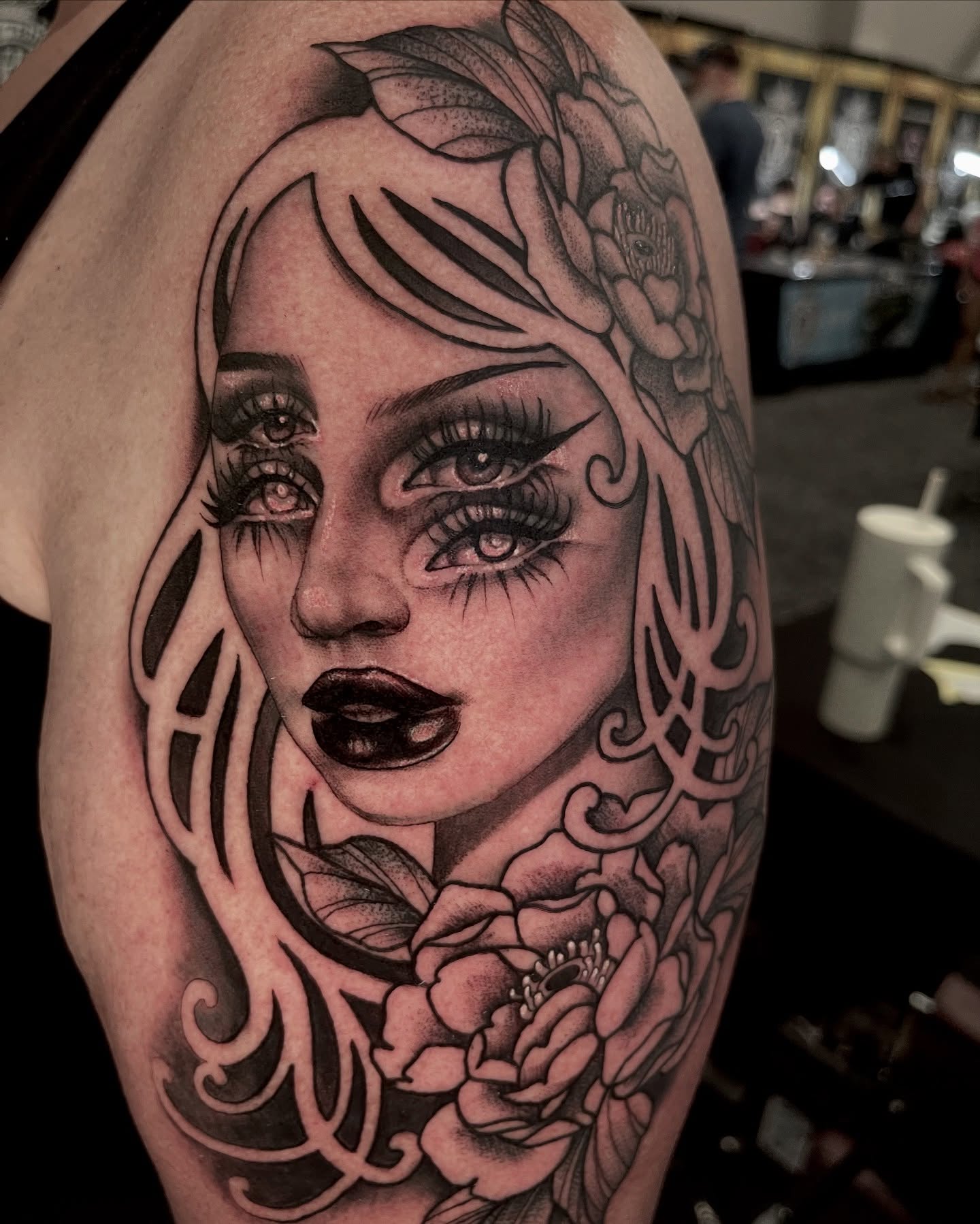 Woman with floral hair realism tattoo on the shoulder by Holli Marie
