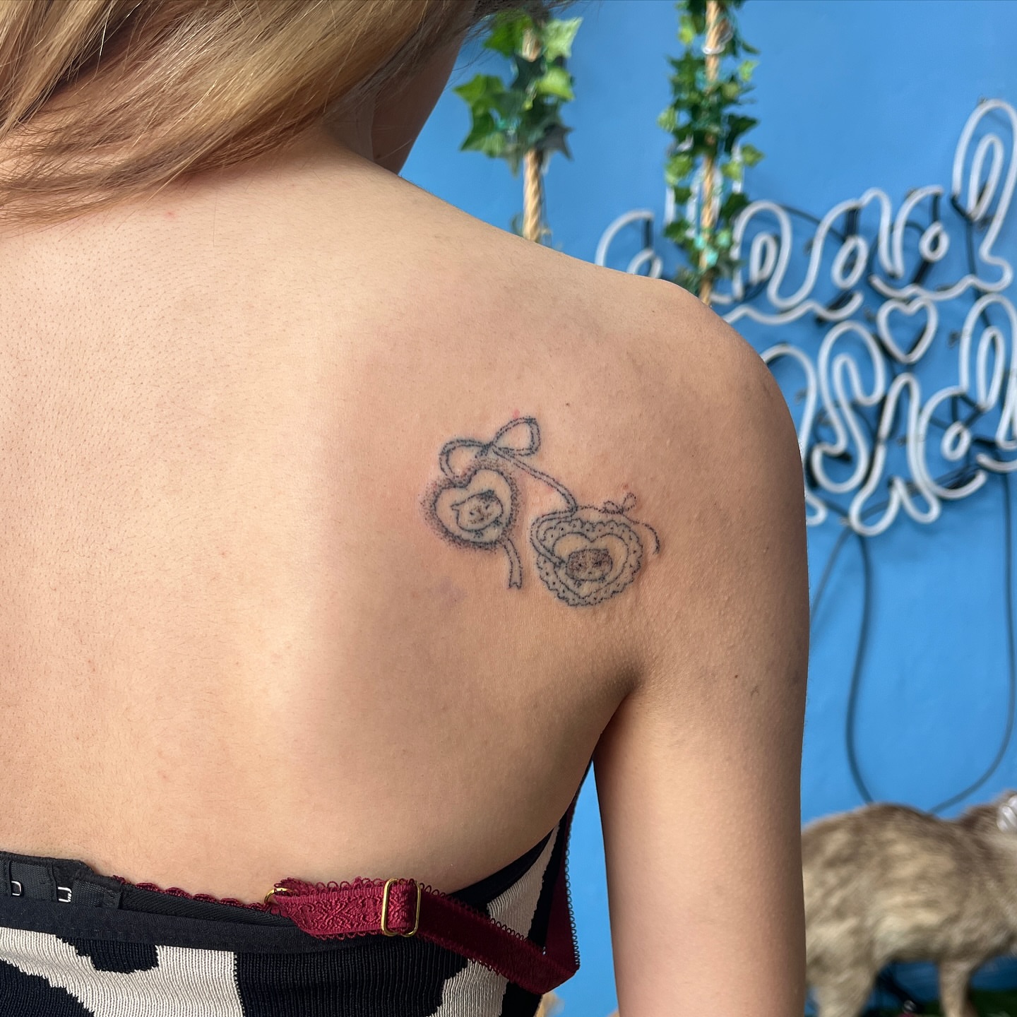 Hearts black and grey tattoo on the shoulder by hana