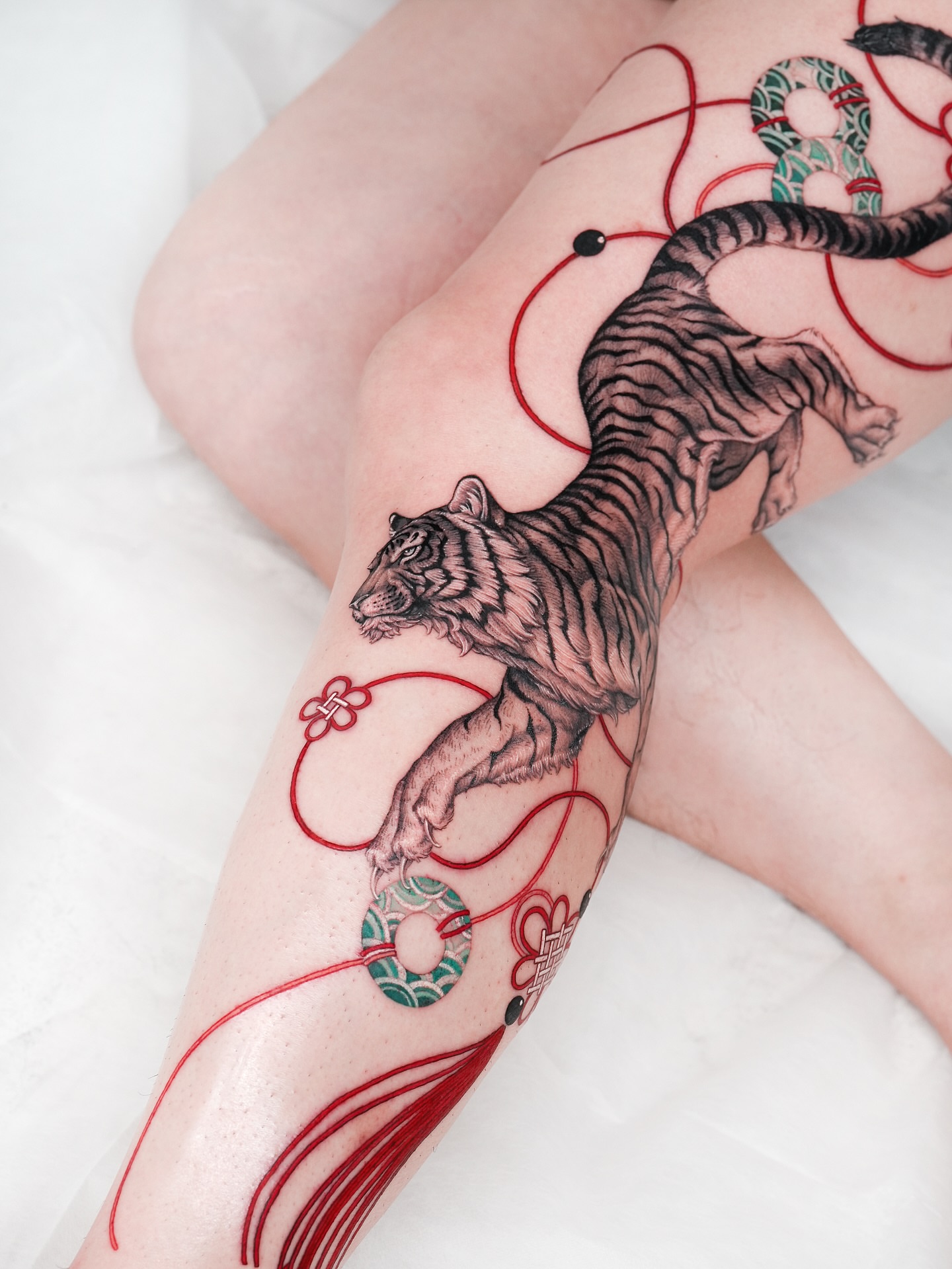 Tiger realism tattoo on the thigh by Intat