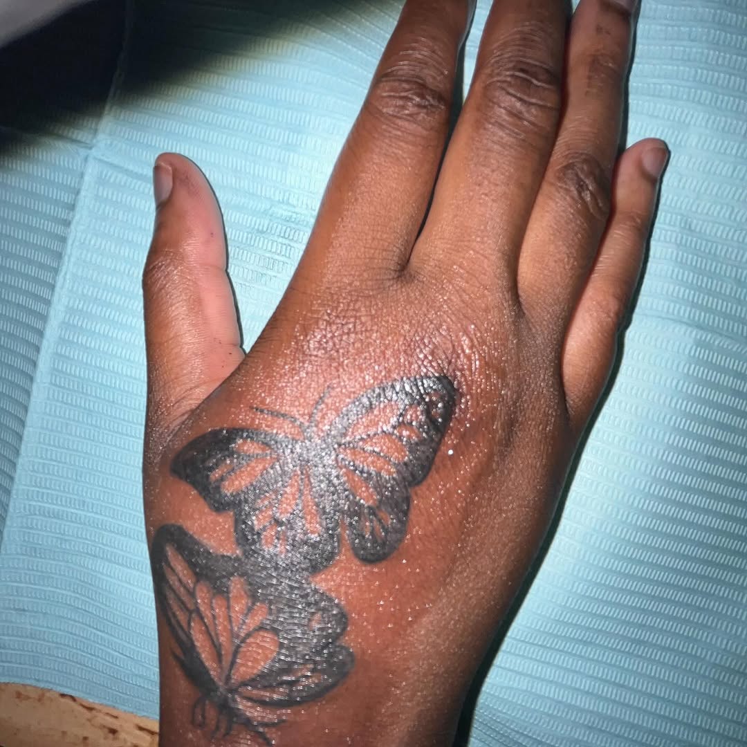 Butterflies fine line tattoo on the hand by Eunoia Tattoos