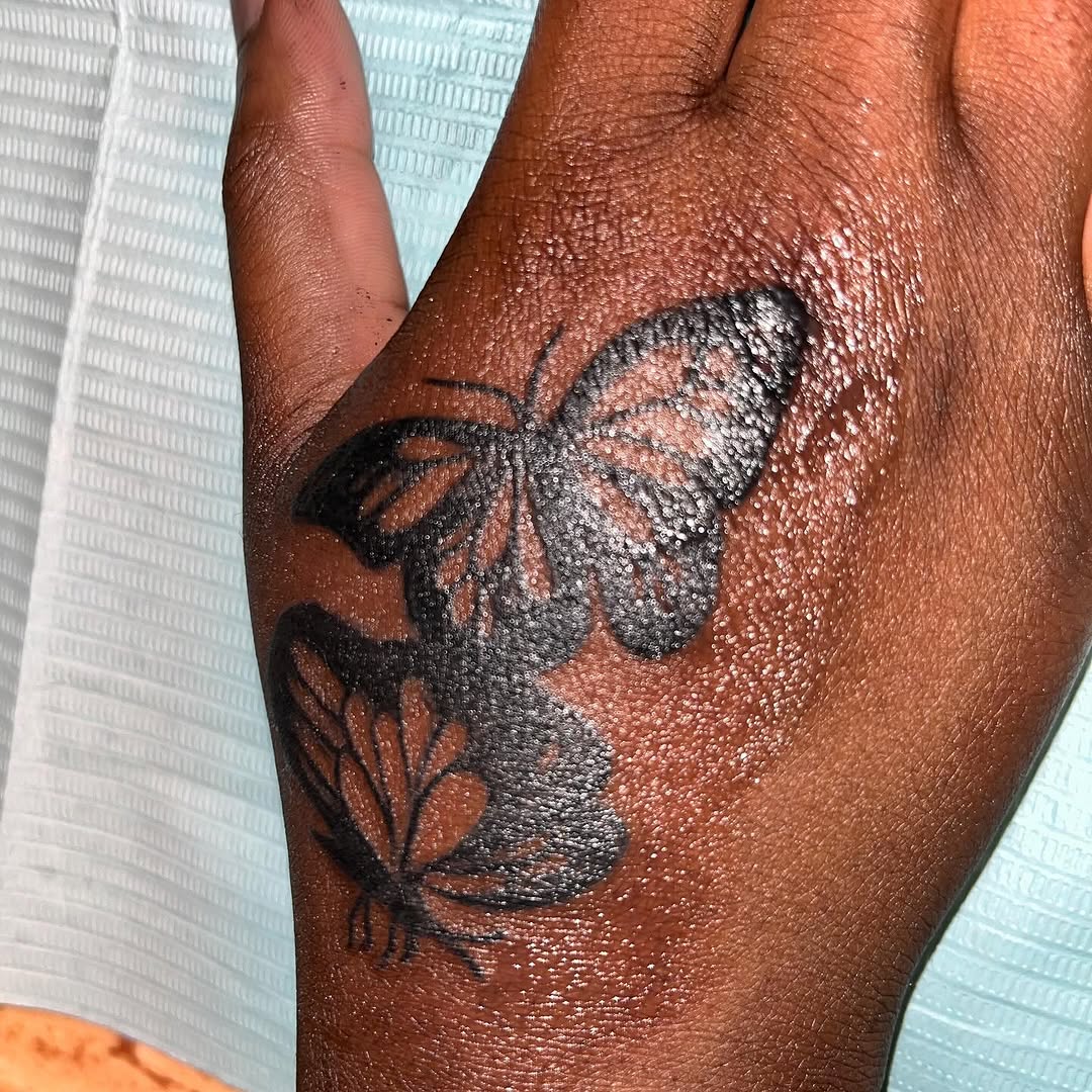 Butterflies fine line tattoo on the hand by Eunoia Tattoos