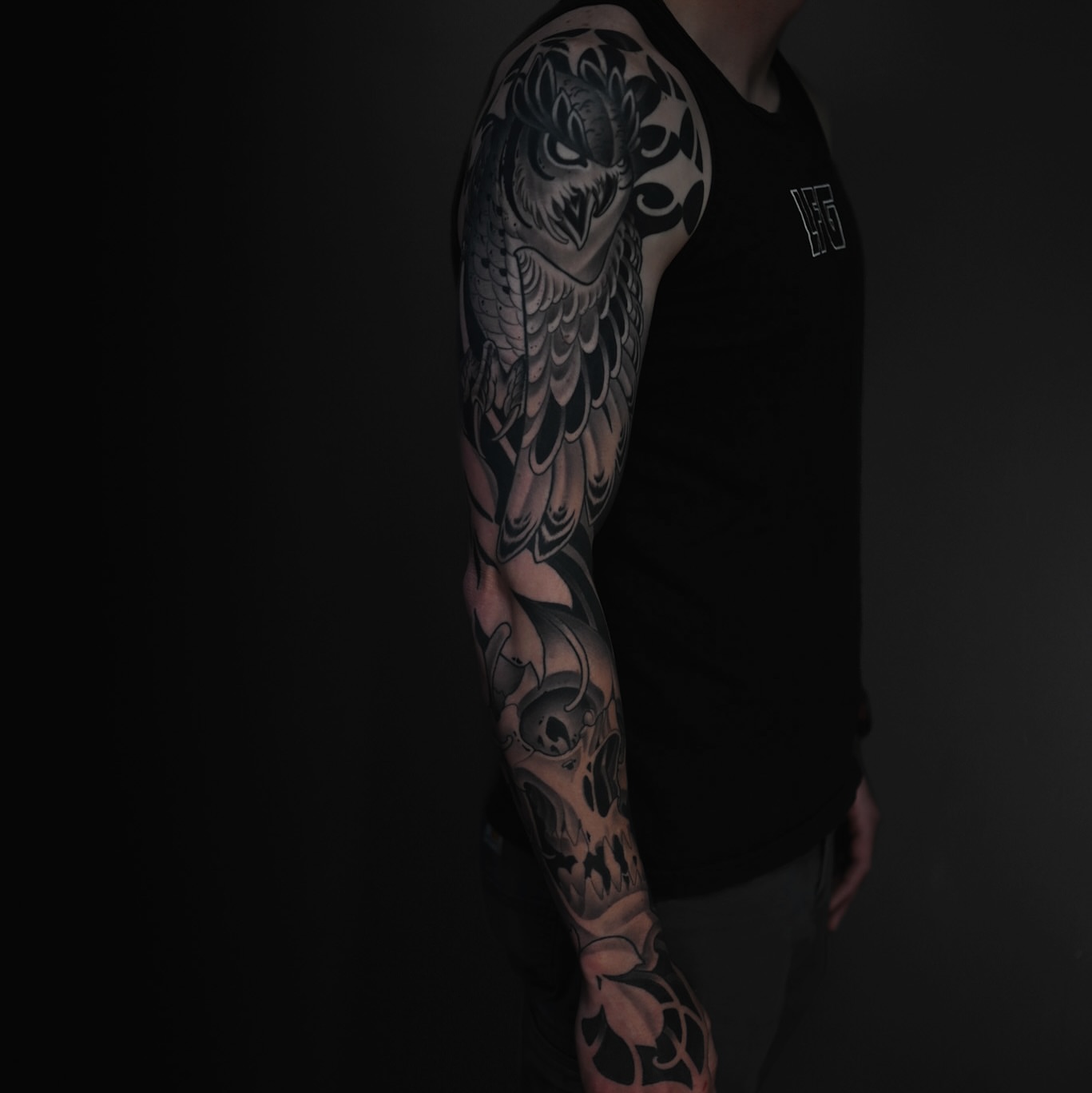 Owl and skull realism tattoo on the upper arm by Ryan Spencer - San Diego Tattoo Artist