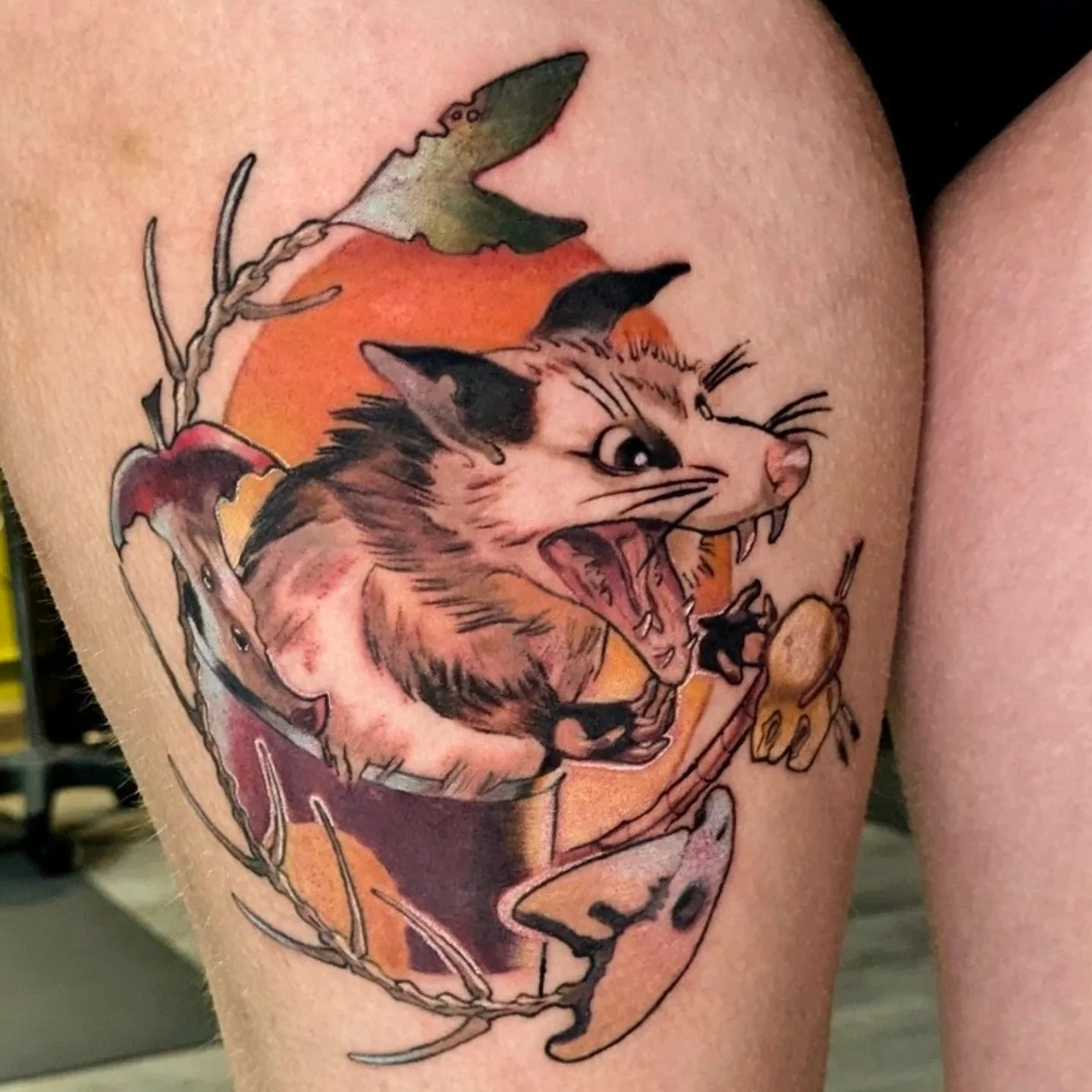 Possum and apple American traditional tattoo on the thigh by Lahel (Lay-el) Fowler
