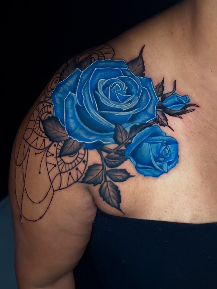 Blue roses realism tattoo on the shoulder by Goga
