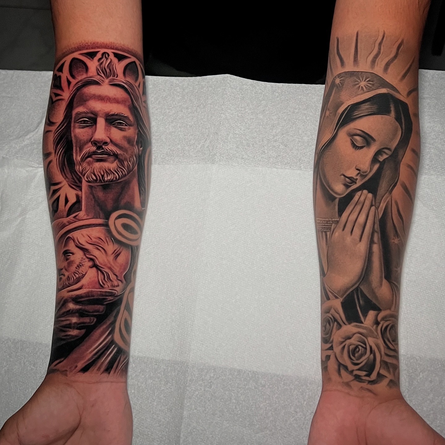 Religious figures realism tattoo on the forearm by Flames, Cerritos, California