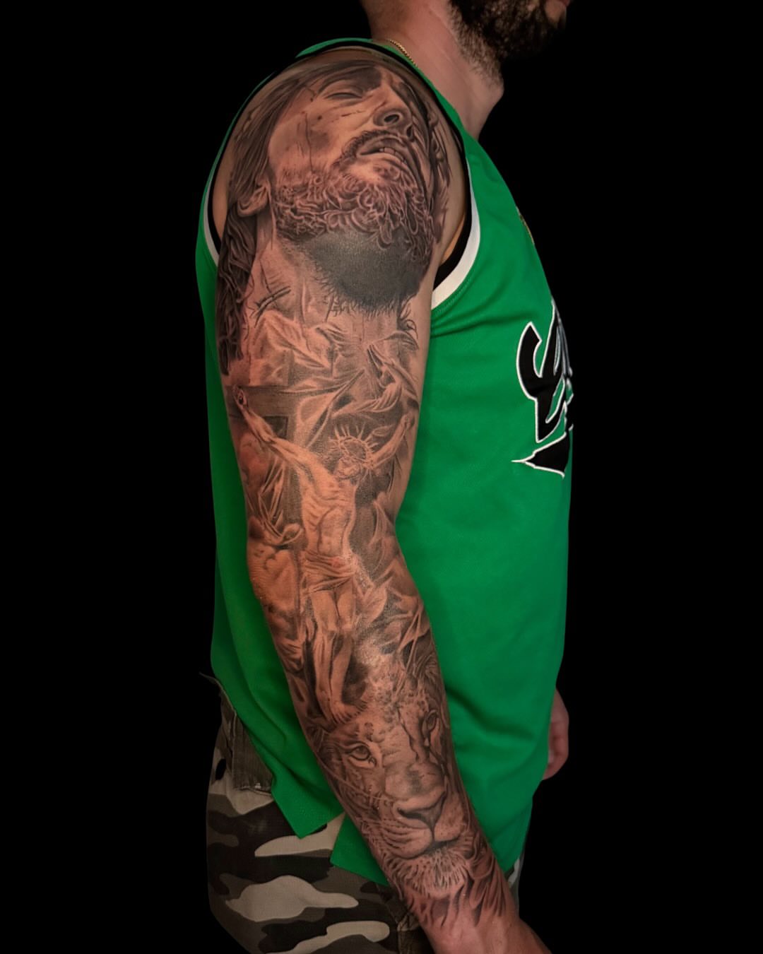 Religious figures realism tattoo on the upper arm by Diana Guillette